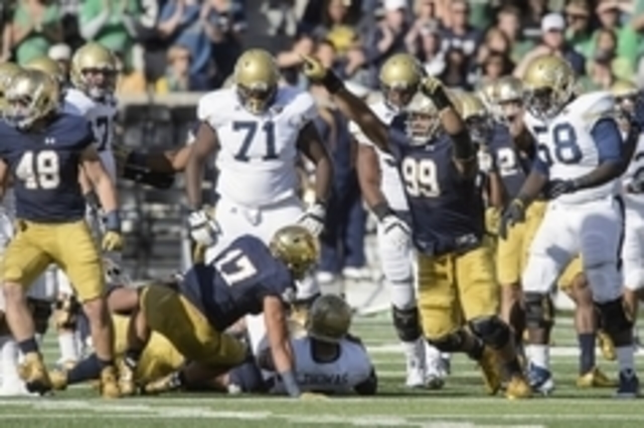Sep 19, 2015; South Bend, IN, USA; Notre Dame Fighting Irish defensive lineman Jerry Tillery (99) celebrates after a tackle of Georgia Tech Yellow Jackets quarterback Justin Thomas (5) in the second quarter at Notre Dame Stadium. Notre Dame won 30-22. Man