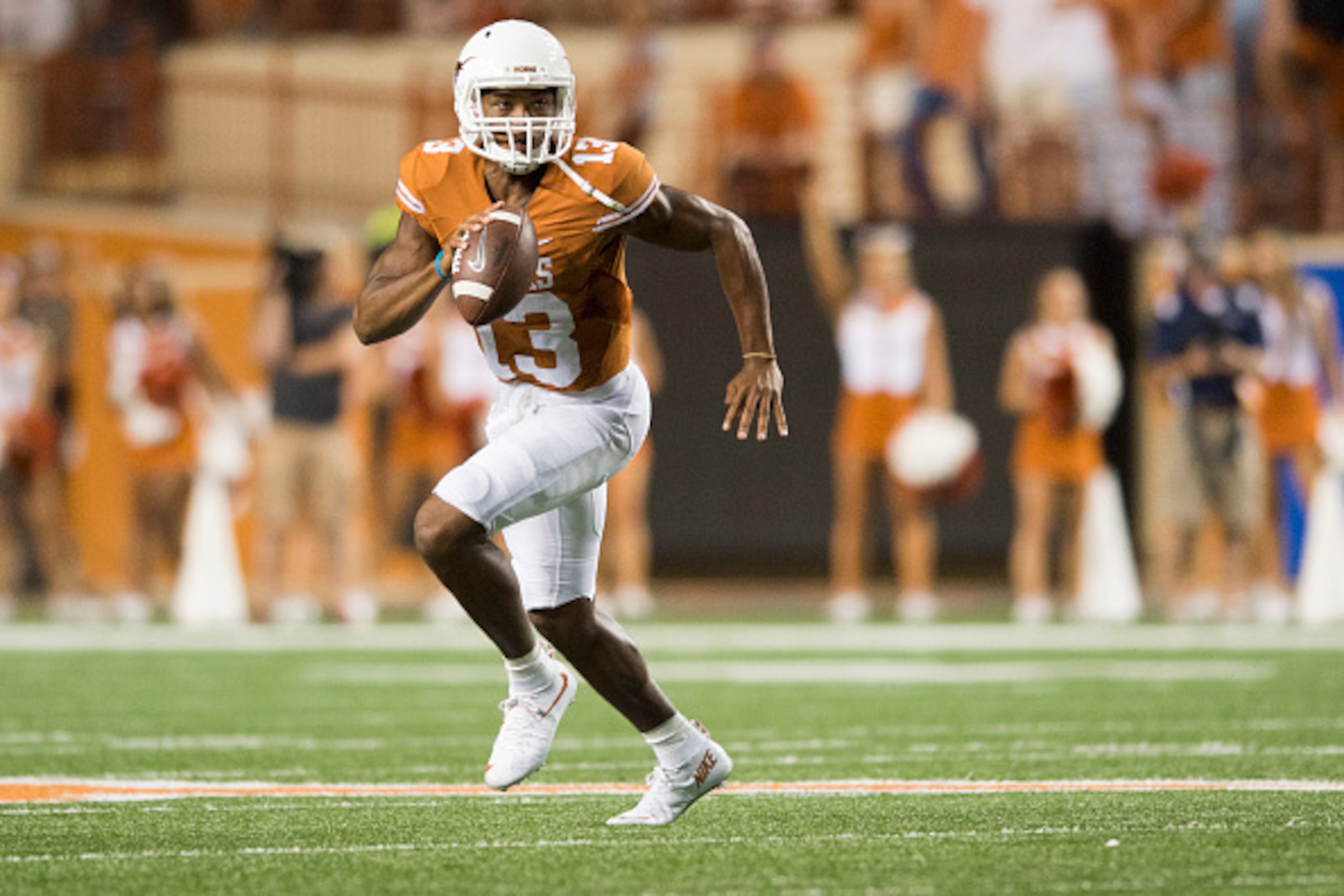 AUSTIN, TX - SEPTEMBER 12:  Jerrod Heard #13 of the Texas Longhorns scrambles against the Rice Owls during the third quarter on September 12, 2015 at Darrell K Royal-Texas Memorial Stadium in Austin, Texas.  (Photo by Cooper Neill/Getty Images)