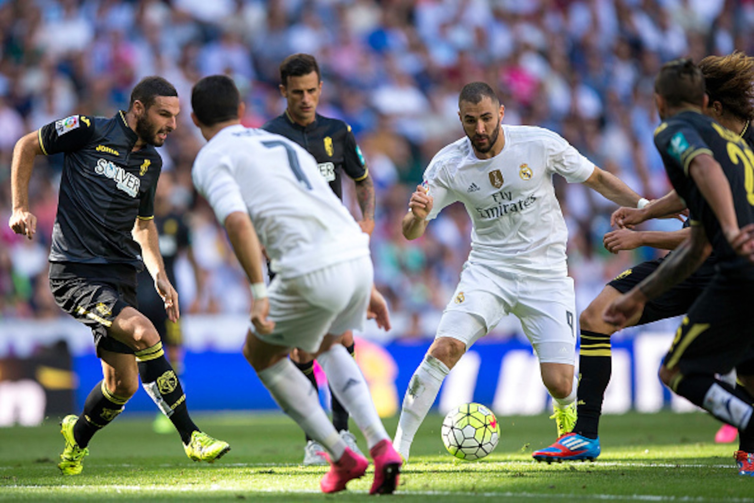 MADRID, SPAIN - SEPTEMBER 19: Karim Benzema (2ndR) of Real Madrid CF competes for the ball with Javier Marquez (3dL) during the La Liga match between Real Madrid CF and Granada CF at Estadio Santiago Bernabeu on September 19, 2015 in Madrid, Spain. (Phot MADRID, SPAIN - SEPTEMBER 19: Karim Benzema (2ndR) of Real Madrid CF competes for the ball with Javier Marquez (3dL) during the La Liga match between Real Madrid CF and Granada CF at Estadio Santiago Bernabeu on September 19, 2015 in Madrid, Spain. (Phot