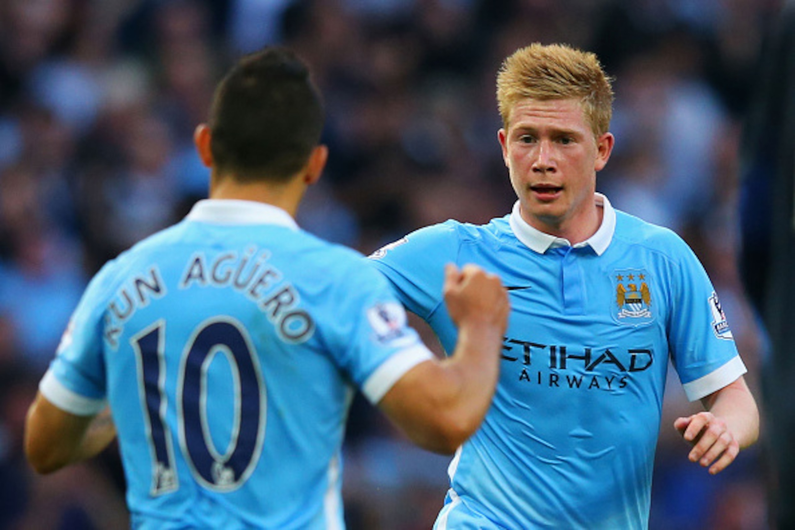 MANCHESTER, ENGLAND - SEPTEMBER 19: Kevin de Bruyne of Manchester City celebrates scoring his team's first goal with his team mate Sergio Aguero  during the Barclays Premier League match between Manchester City and West Ham United at Etihad Stadium on Sep