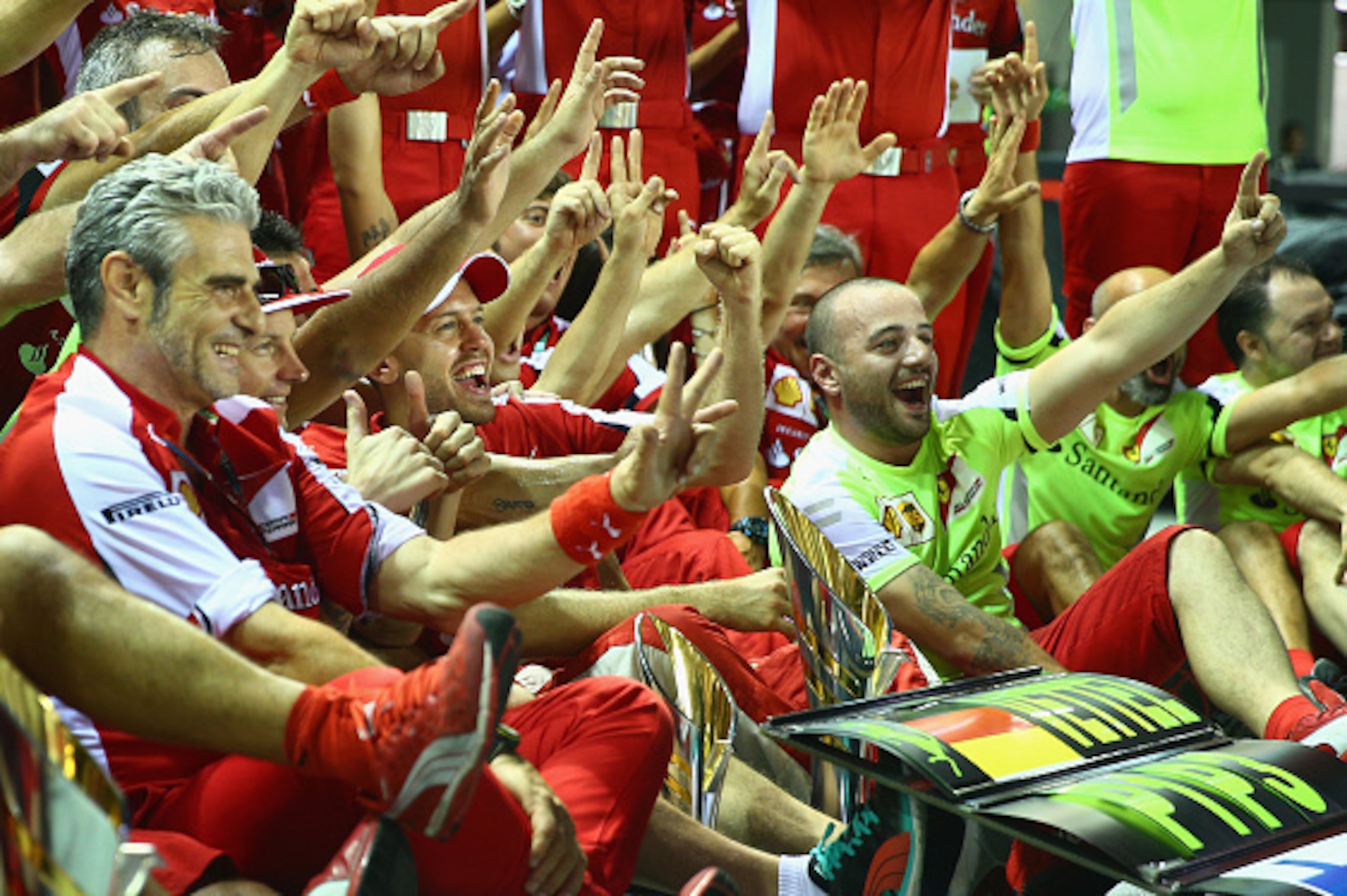 SINGAPORE - SEPTEMBER 20:  Sebastian Vettel of Germany and Ferrari celebrates with his team, including Kimi Raikkonen of Finland and Ferrari and Ferrari Team Principal Maurizio Arrivabene after winning the Formula One Grand Prix of Singapore at Marina Bay