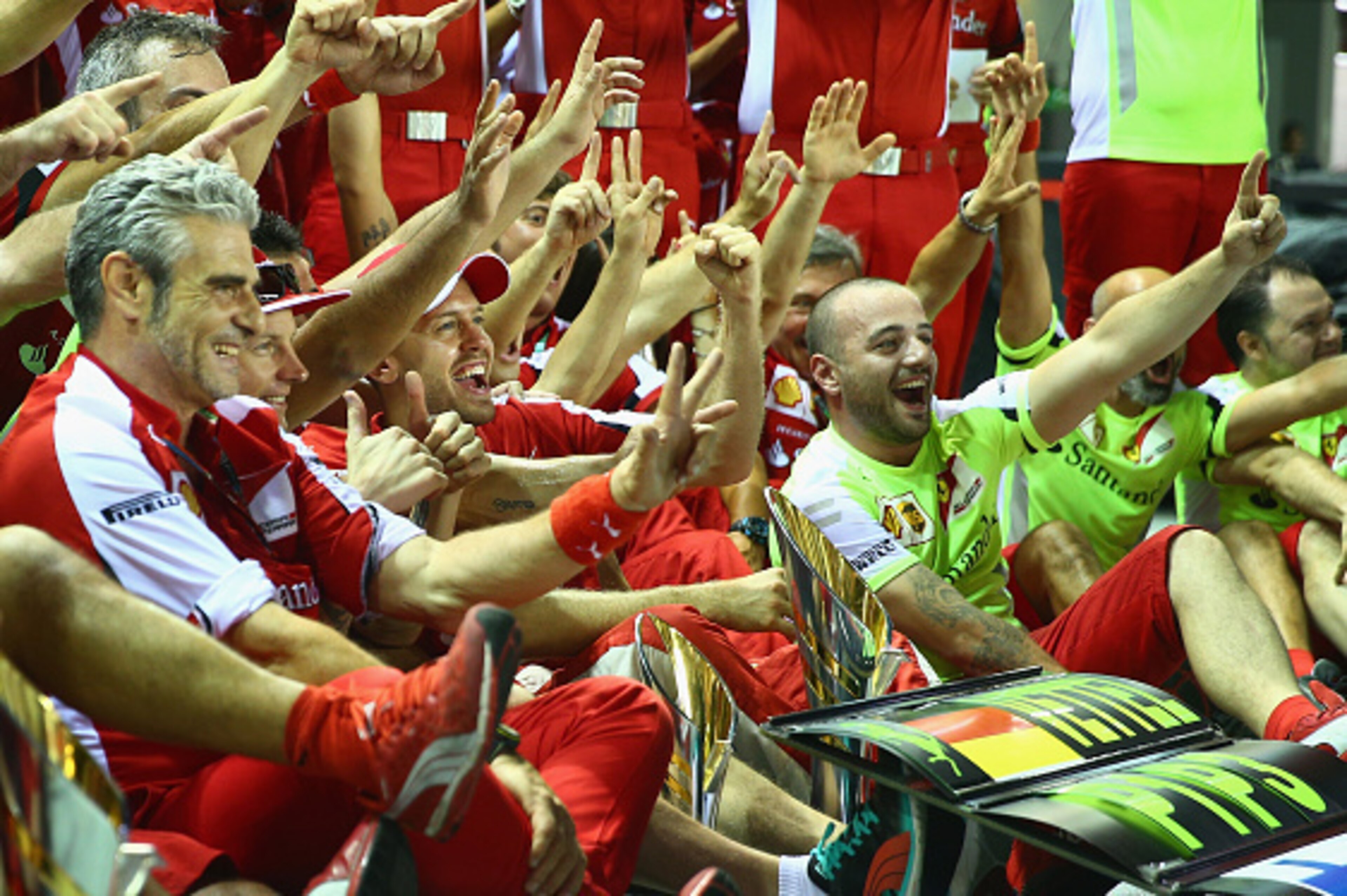 SINGAPORE - SEPTEMBER 20:  Sebastian Vettel of Germany and Ferrari celebrates with his team, including Kimi Raikkonen of Finland and Ferrari and Ferrari Team Principal Maurizio Arrivabene after winning the Formula One Grand Prix of Singapore at Marina Bay