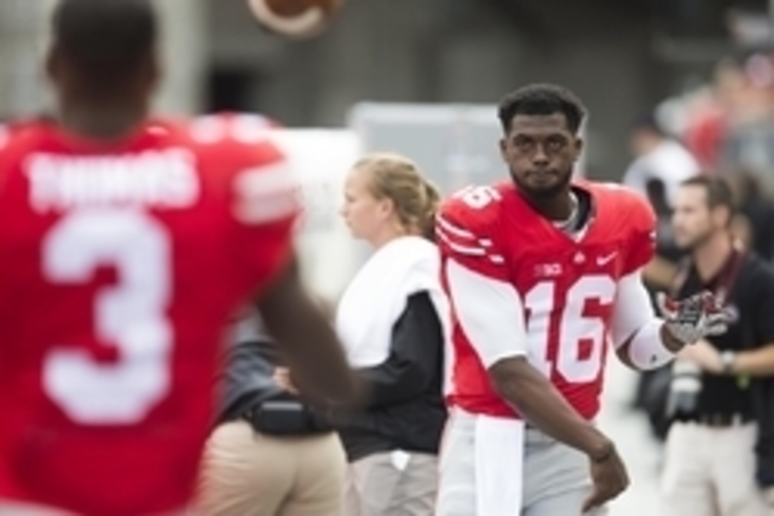 Sep 19, 2015; Columbus, OH, USA; Ohio State Buckeyes quarterback J.T. Barrett (16) loosens up on the sideline after the second interception of the game by Ohio State Buckeyes quarterback Cardale Jones (not shown) against the Northern Illinois Huskies at O