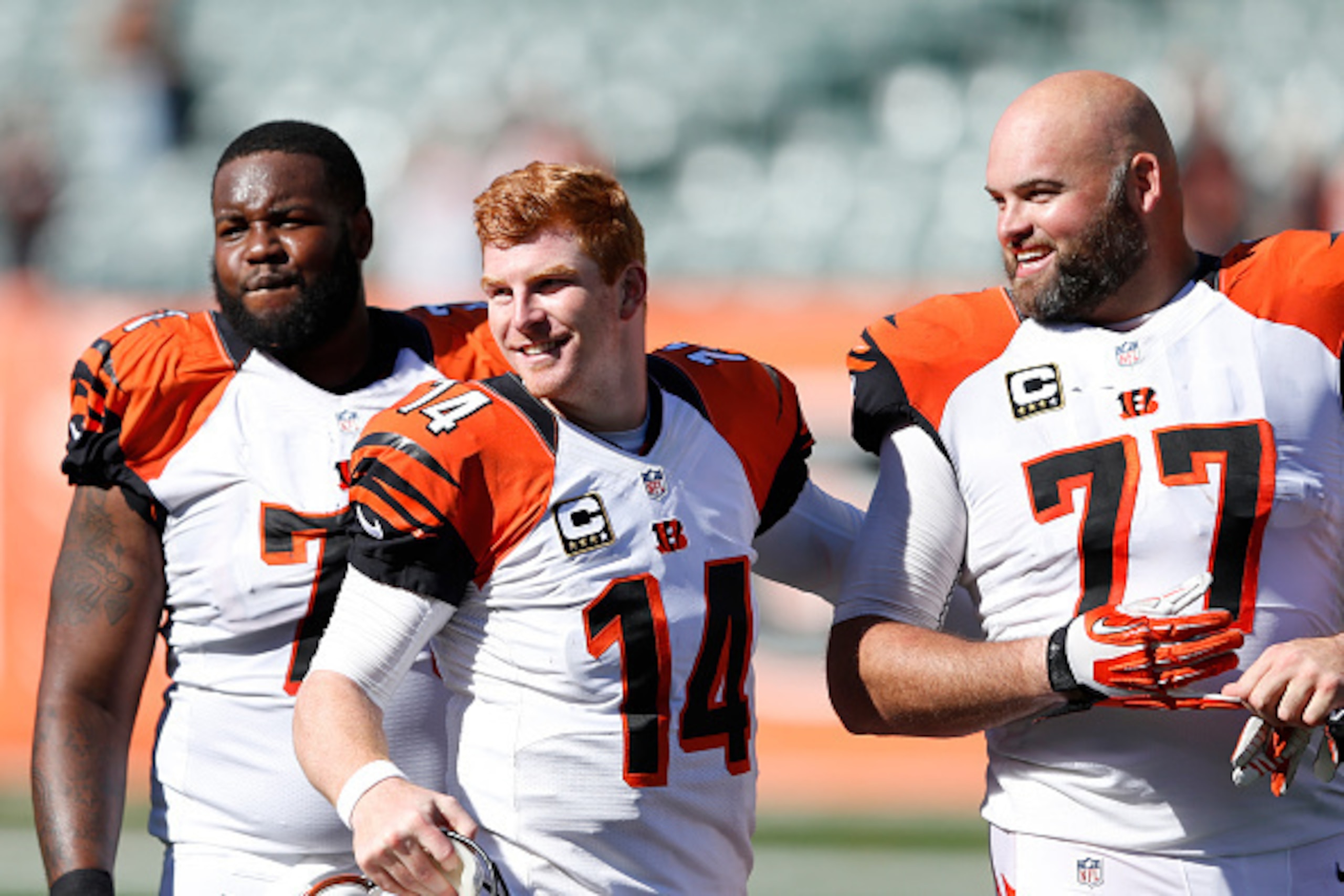 CINCINNATI, OH - SEPTEMBER 14: Andy Dalton #14 of the Cincinnati Bengals jokes with Andre Smith #71 and Andrew Whitworth #77 after the game against the Atlanta Falcons at Paul Brown Stadium on September 14, 2014 in Cincinnati, Ohio. The Bengals won 24-10.