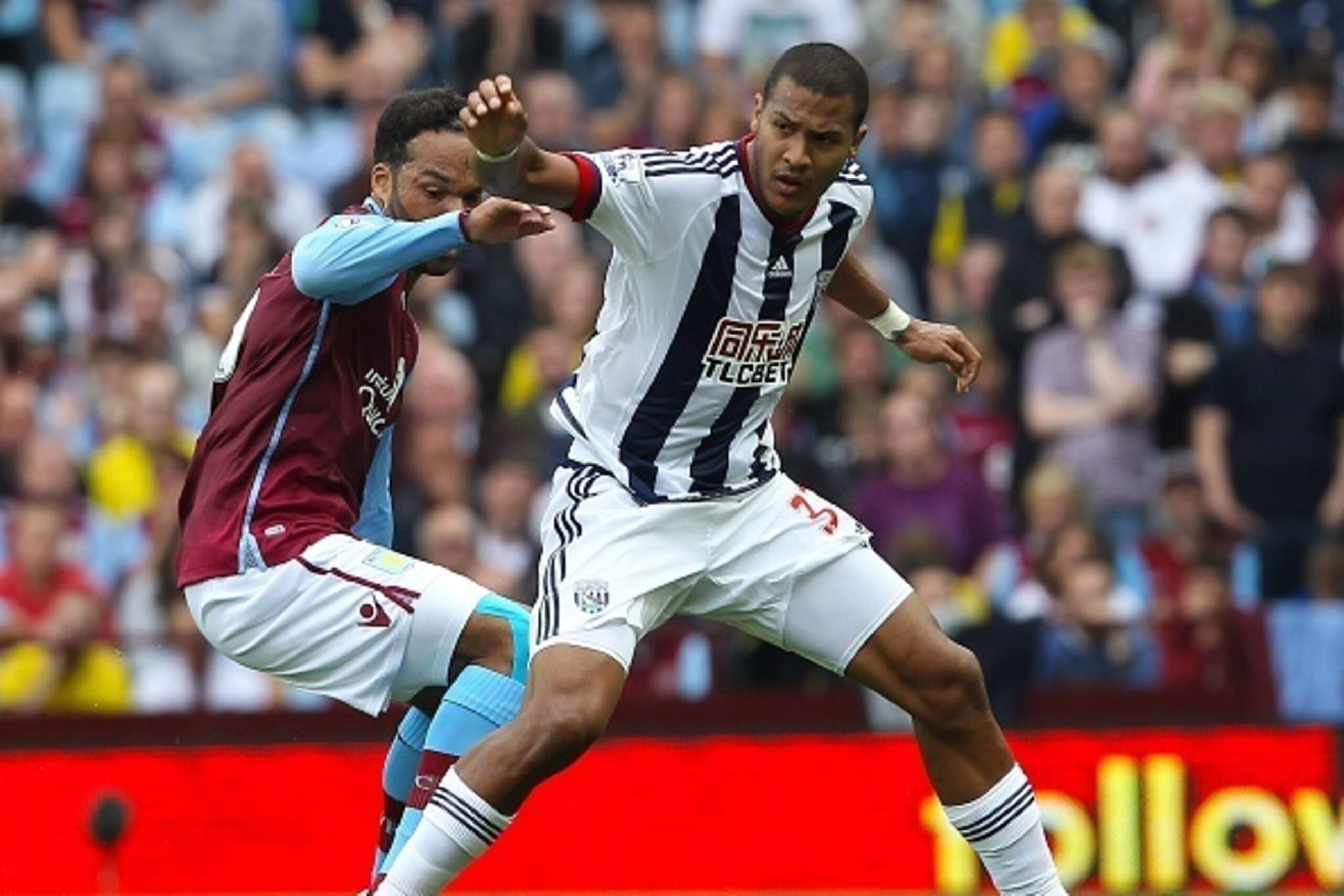 Aston Villa's English defender Joleon Lescott  (L) vies with West Bromwich Albion's Venezuelan striker Salomon Rondon during the English Premier League football match between Aston Villa and West Bromwich Albion at Villa Park in Birmingham, central Englan