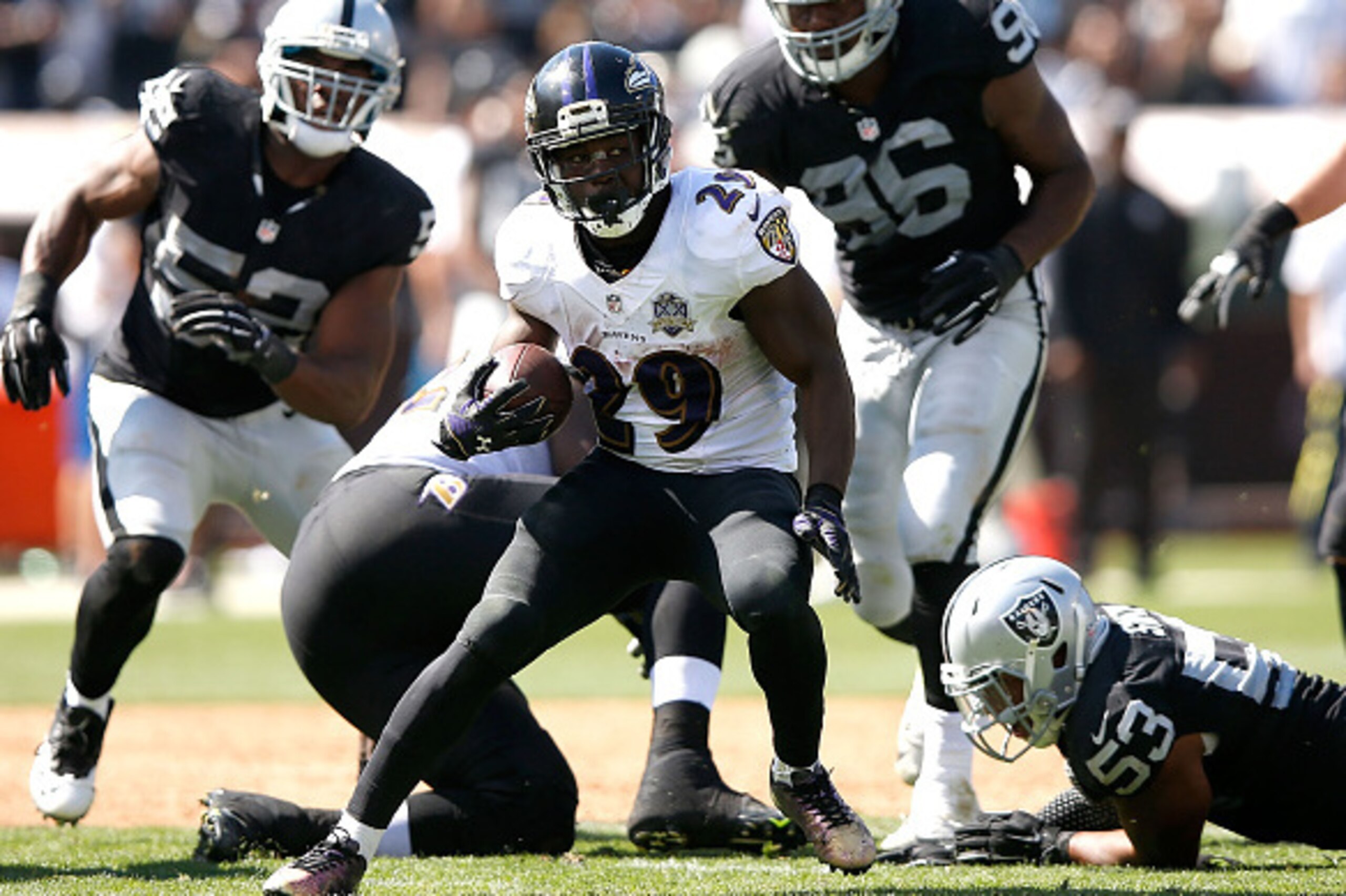 OAKLAND, CA - SEPTEMBER 20:  Justin Forsett #29 of the Baltimore Ravens runs through the block of the Oakland Raiders in the second quarter at Oakland-Alameda County Coliseum on September 20, 2015 in Oakland, California.  (Photo by Ezra Shaw/Getty Images)