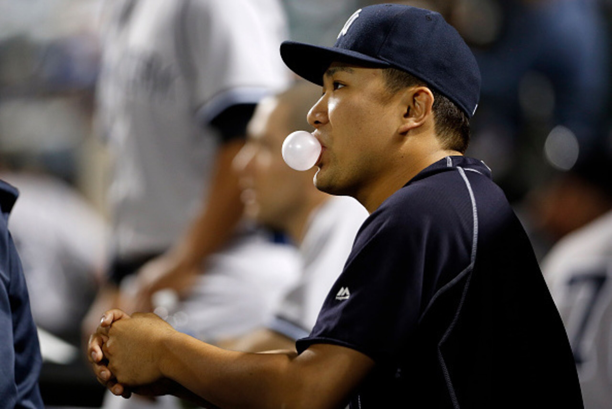 NEW YORK, NY - SEPTEMBER 20: Masahiro Tanaka #19 of the New York Yankees blows a bubble prior to taking on the New York Mets at Citi Field on September 20, 2015 in the Queens borough of New York City. (Photo by Adam Hunger/Getty Images)