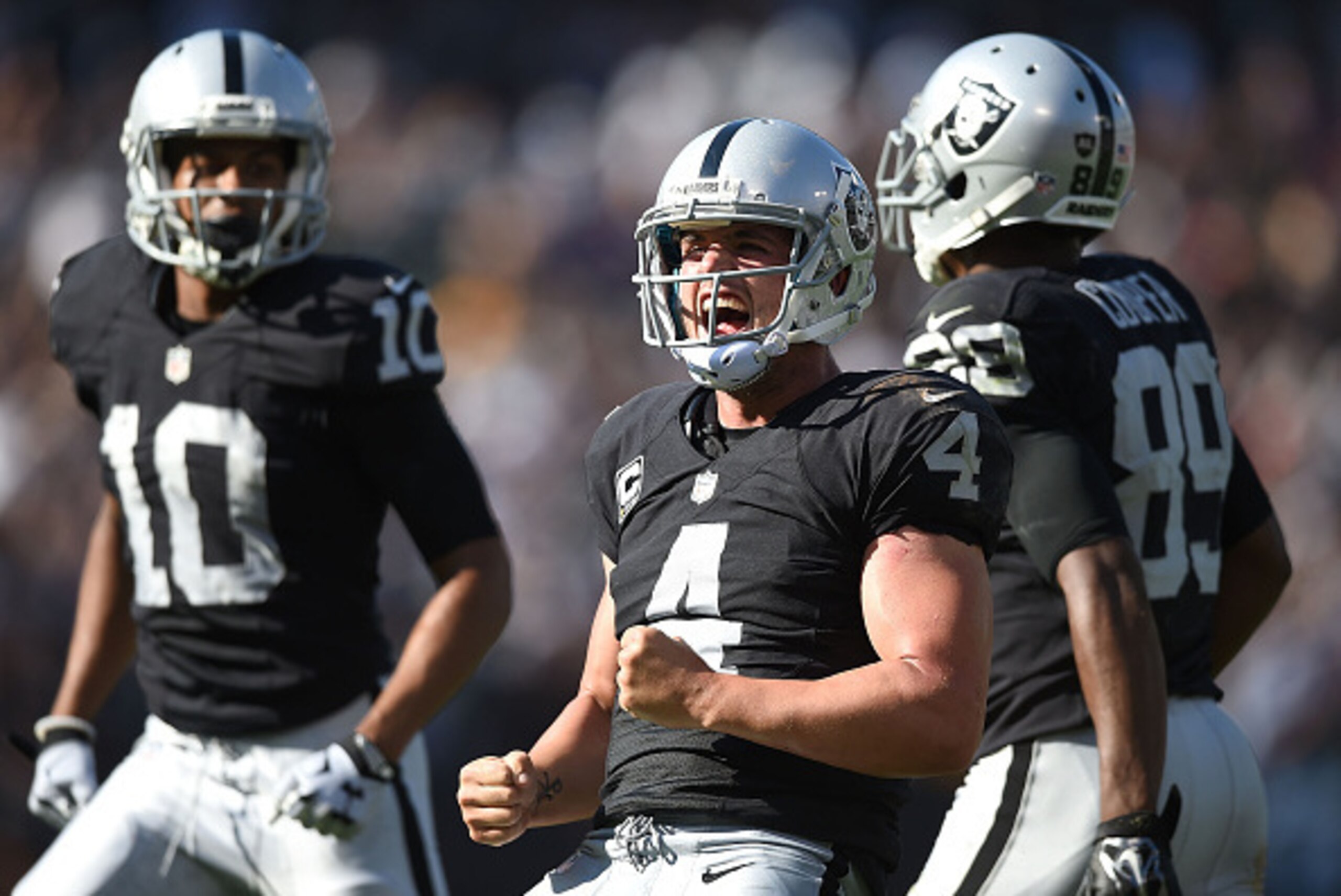OAKLAND, CA - SEPTEMBER 20:  Derek Carr #4 of the Oakland Raiders celebrates the game winning touchdown in the fourth quarter against the Baltimore Ravens at Oakland-Alameda County Coliseum on September 20, 2015 in Oakland, California.  (Photo by Thearon 