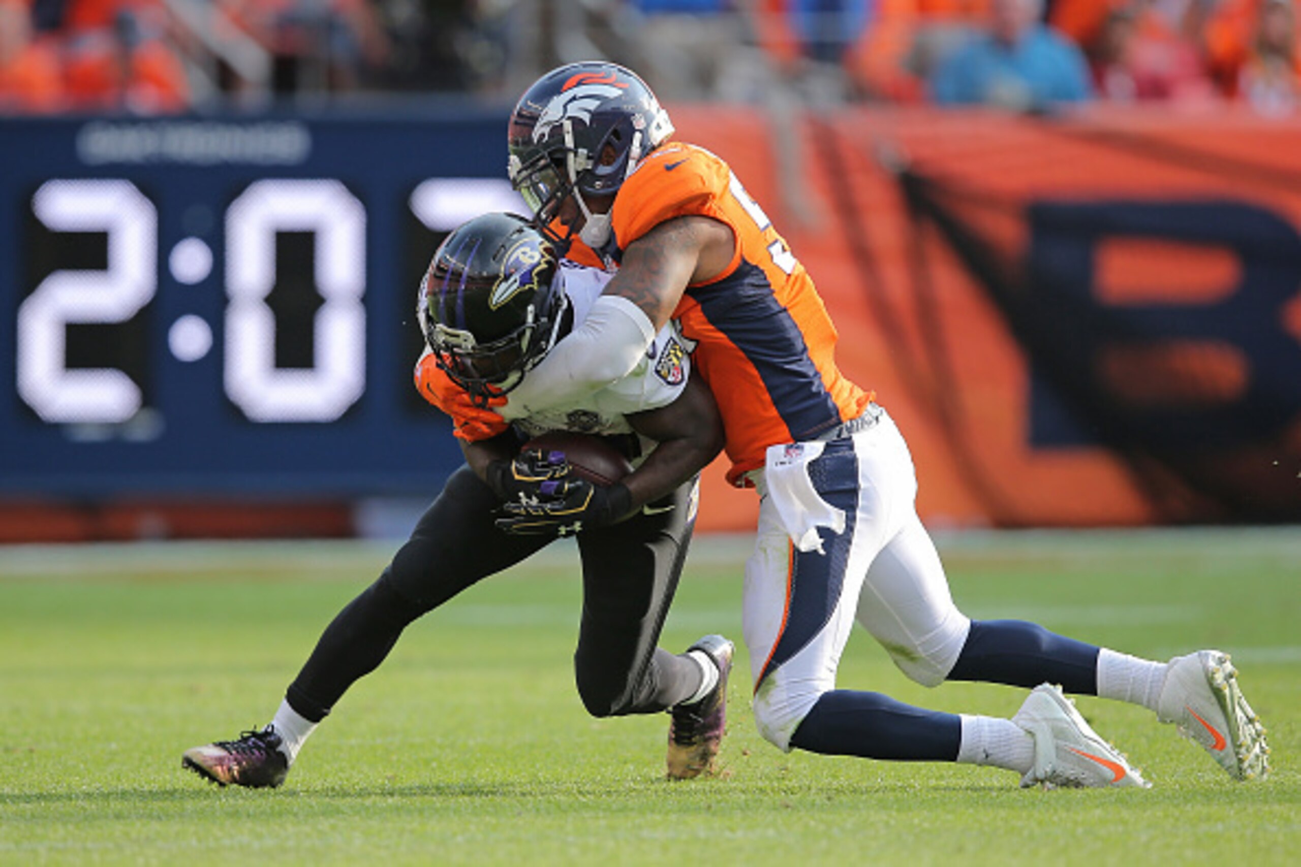 DENVER, CO - SEPTEMBER 13:  Justin Forsett #29 of the Baltimore Ravens carries the ball and Brandon Marshall #54 of the Denver Broncos makes the tackle at Sports Authority Field at Mile High on September 13, 2015 in Denver, Colorado. The Broncos defeated 