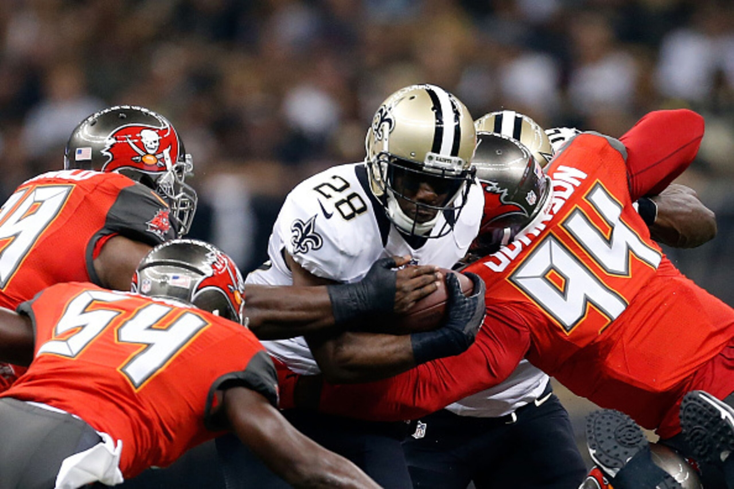 NEW ORLEANS, LA - SEPTEMBER 20:  C.J. Spiller #28 of the New Orleans Saints is brought down by George Johnson #94 and Lavonte David #54 of the Tampa Bay Buccaneers during the first quarter of a game at the Mercedes-Benz Superdome on September 20, 2015 in 