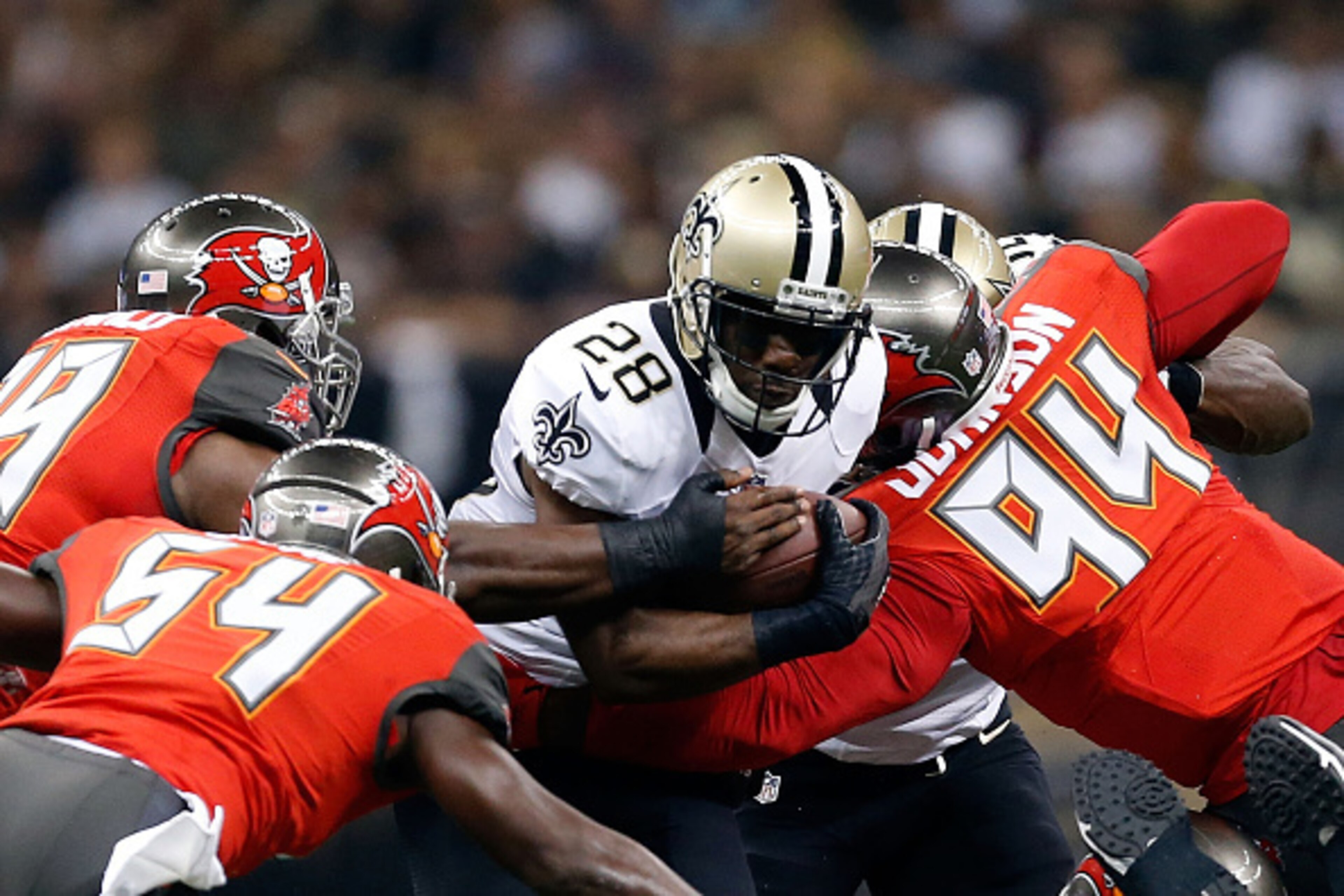 NEW ORLEANS, LA - SEPTEMBER 20:  C.J. Spiller #28 of the New Orleans Saints is brought down by George Johnson #94 and Lavonte David #54 of the Tampa Bay Buccaneers during the first quarter of a game at the Mercedes-Benz Superdome on September 20, 2015 in 