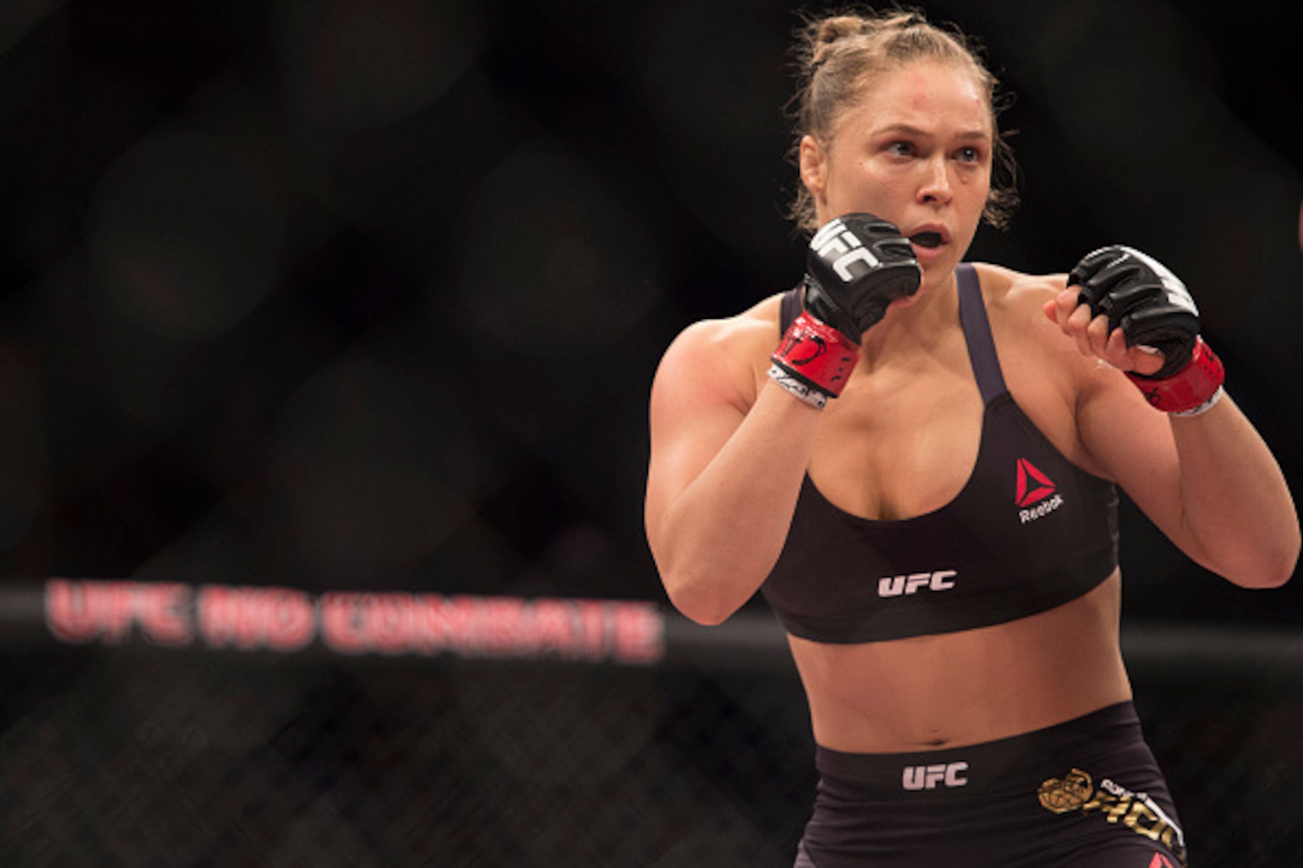 RIO DE JANEIRO, BRAZIL - AUGUST 01:  UFC women's bantamweight champion Ronda Rousey of the United States rushes forward against Bethe Correia of Brazil during the UFC 190 event inside HSBC Arena on August 1, 2015 in Rio de Janeiro, Brazil.  (Photo by Jeff