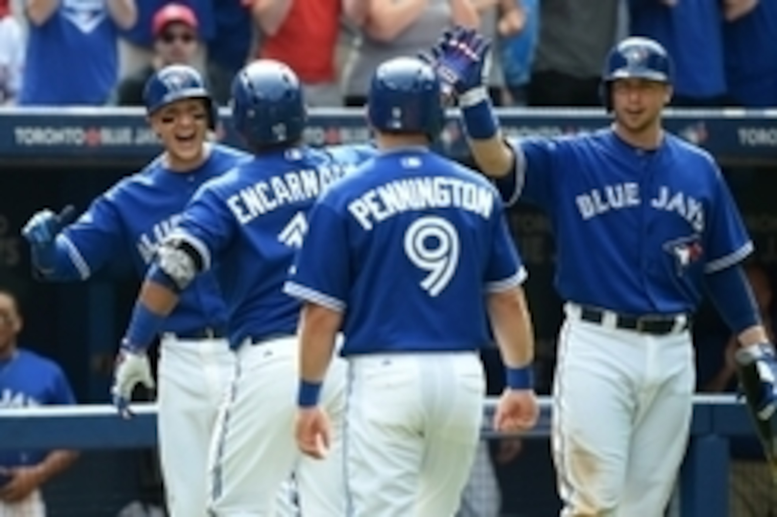 Aug 29, 2015; Toronto, Ontario, CAN; Toronto Blue Jays designated hitter Edwin Encarnacion (10) is greeted by shortstop Troy Tulowitzki (2) and third baseman Cliff Pennington (9) and first baseman Justin Smoak (13) after hitting a grand slam home run agai