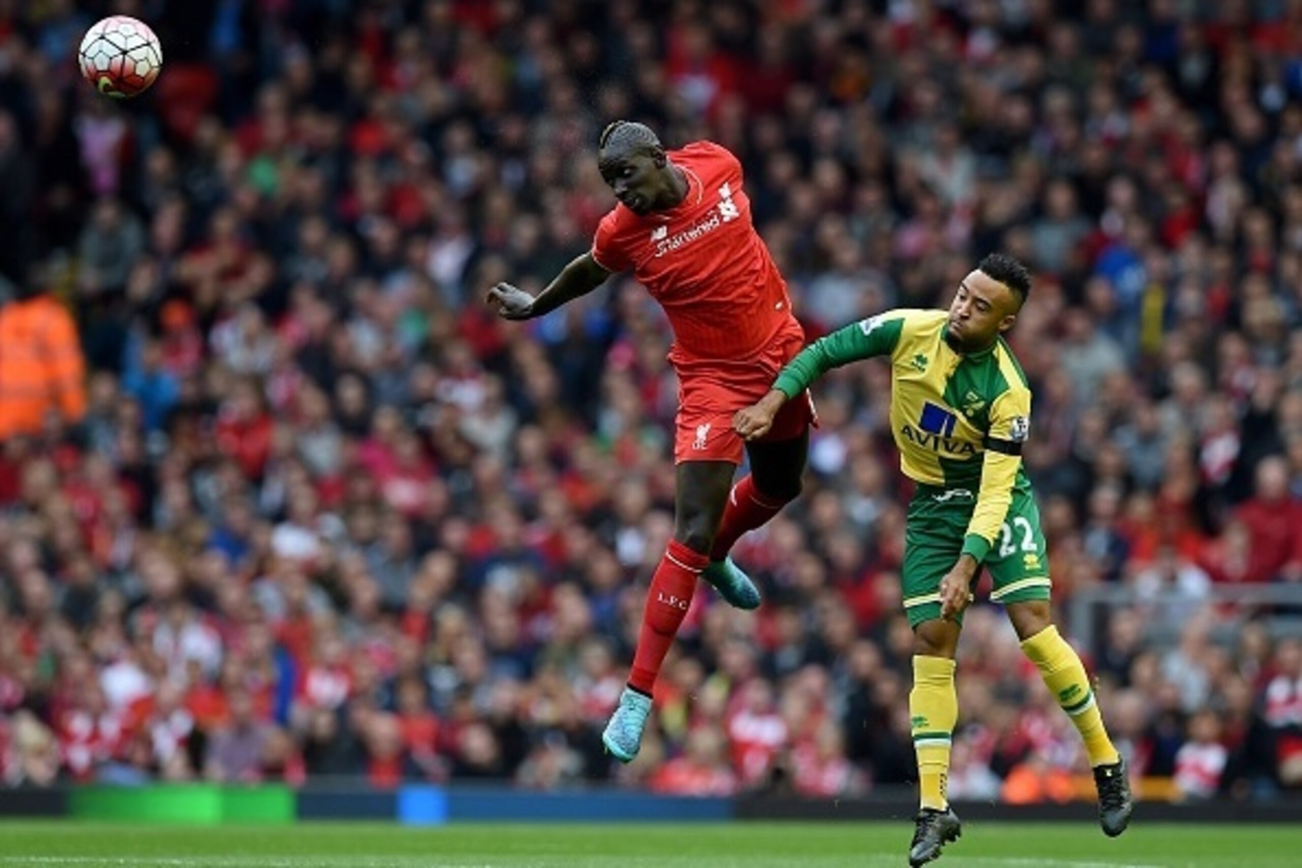 Liverpool's French defender Mamadou Sakho (L) challenges Norwich City's English midfielder Nathan Redmond during the English Premier League football match between Liverpool and Norwich City at the Anfield stadium in Liverpool, north-west England, on Septe