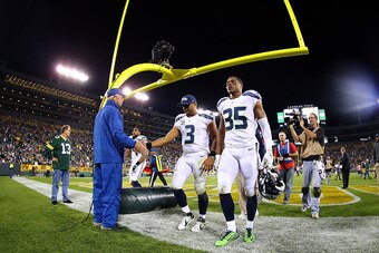 GREEN BAY, WI - SEPTEMBER 20:  Russell Wilson #3 and DeShawn Shead #35 of the Seattle Seahawks walk off the field after being defeated by the Green Bay Packers in their game at Lambeau Field on September 20, 2015 in Green Bay, Wisconsin.  The Green Bay Pa