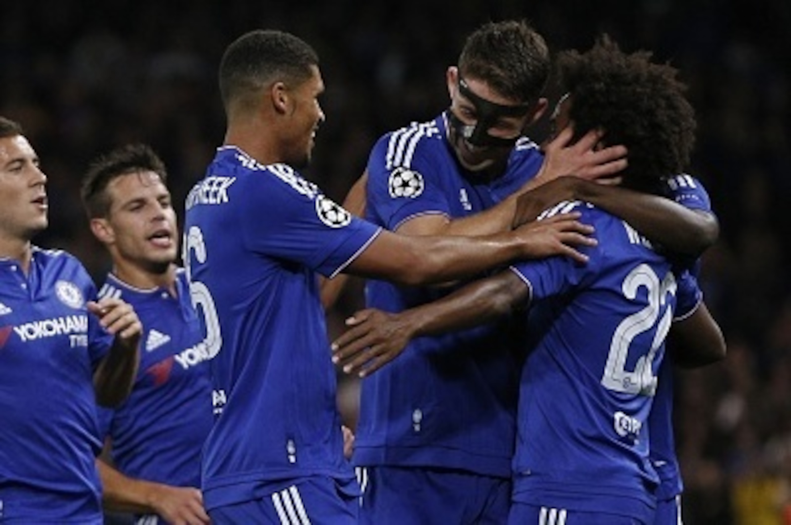 Chelsea's English defender Gary Cahill (2R) and Chelsea's English midfielder Ruben Loftus-Cheek (3R) congratulate Chelsea's Brazilian midfielder Willian (R) for scoring a goal during the UEFA Champions League, group G, football match between Chelsea and M