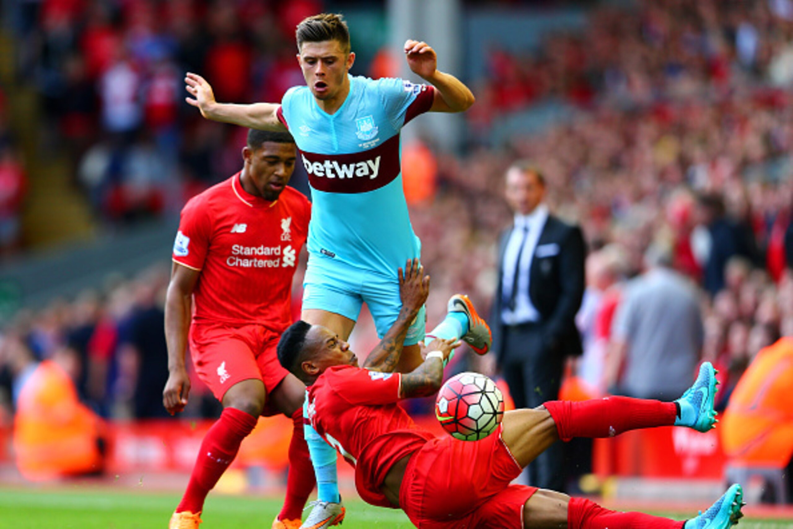 LIVERPOOL, ENGLAND - AUGUST 29:  Aaron Cresswell of West Ham United and Nathaniel Clyne of Liverpool compete for the ball during the Barclays Premier League match between Liverpool and West Ham United at Anfield on August 29, 2015 in Liverpool, England.  