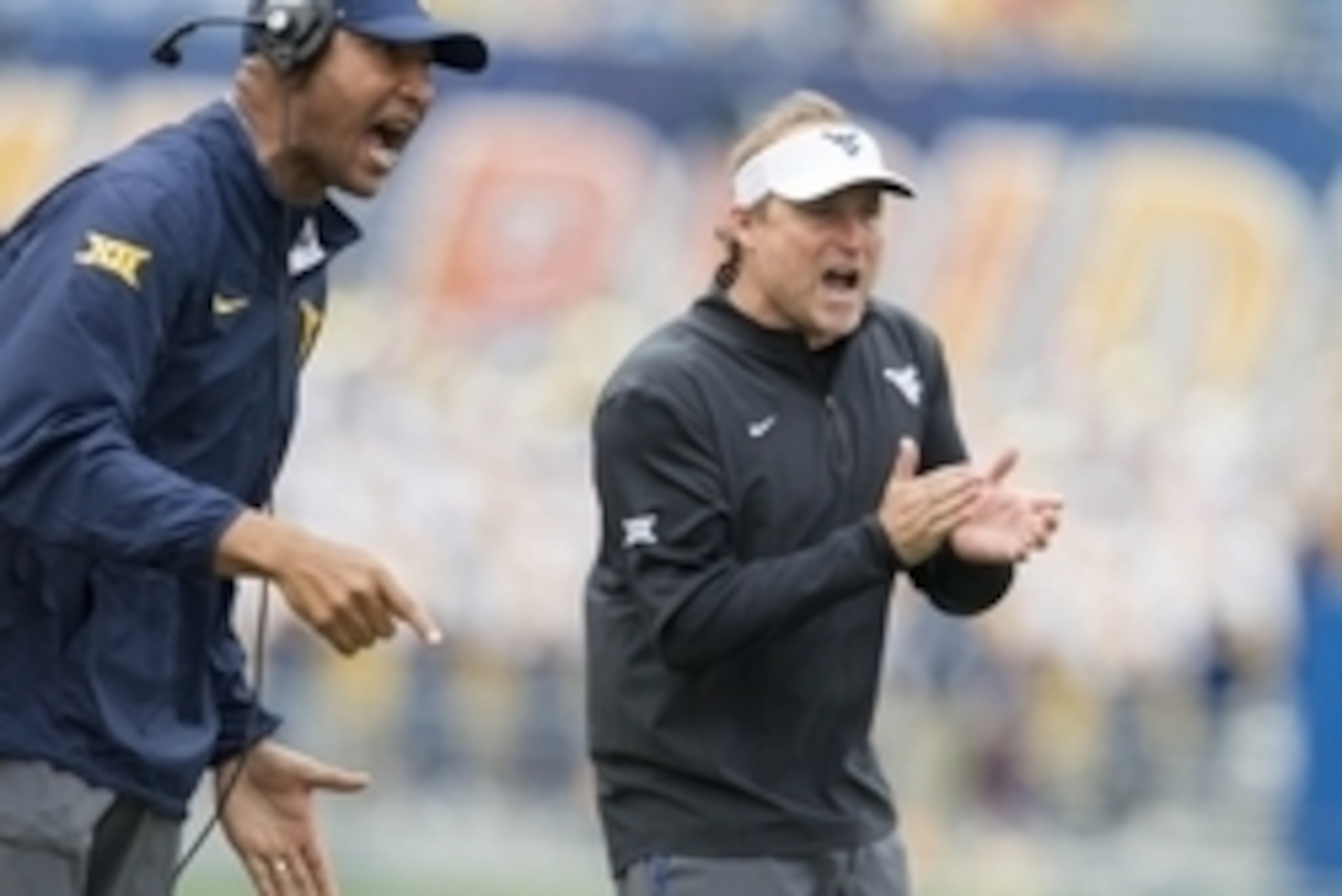 Sep 12, 2015; Morgantown, WV, USA; West Virginia Mountaineers head coach Dana Holgorsen celebrates after scoring during the third quarter against the Liberty Flames at Milan Puskar Stadium. Mandatory Credit: Ben Queen-USA TODAY Sports