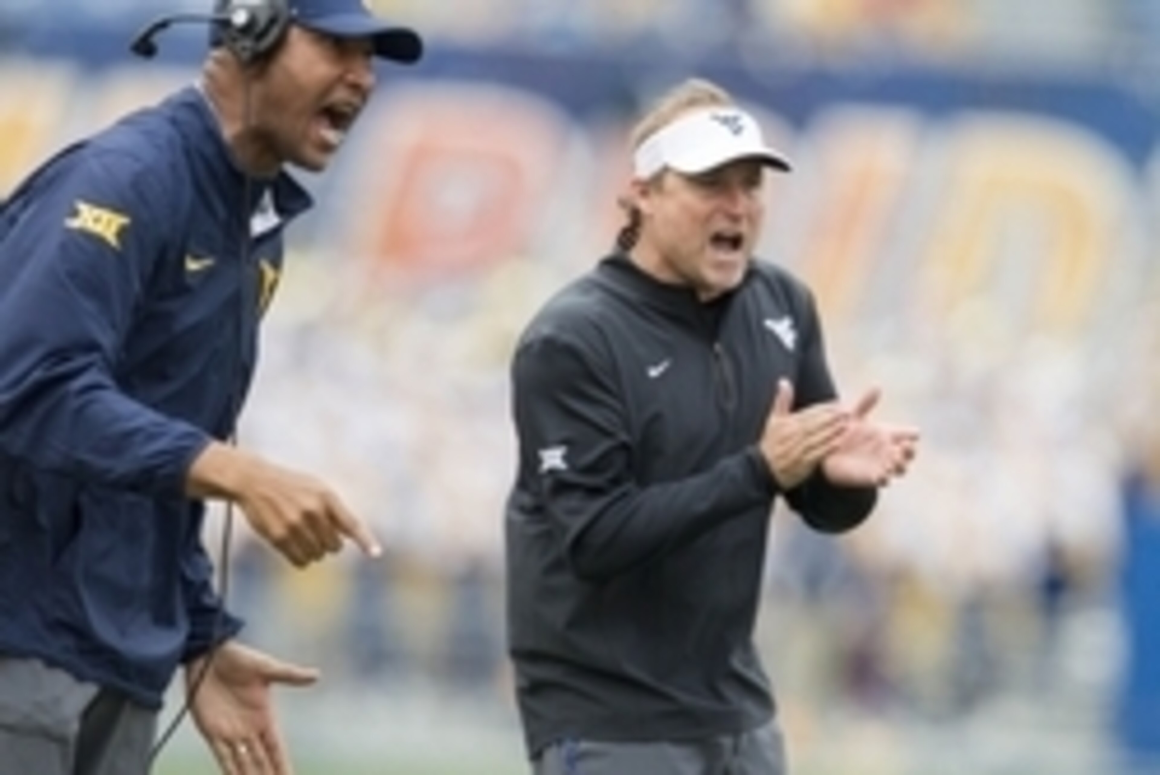 Sep 12, 2015; Morgantown, WV, USA; West Virginia Mountaineers head coach Dana Holgorsen celebrates after scoring during the third quarter against the Liberty Flames at Milan Puskar Stadium. Mandatory Credit: Ben Queen-USA TODAY Sports