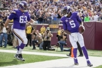 Sep 20, 2015; Minneapolis, MN, USA; Minnesota Vikings quarterback Teddy Bridgewater (5) smiles and celebrates with guard Brandon Fusco (63) after scoring a touchdown in the first half against the Detroit Lions at TCF Bank Stadium. Mandatory Credit: Jesse
