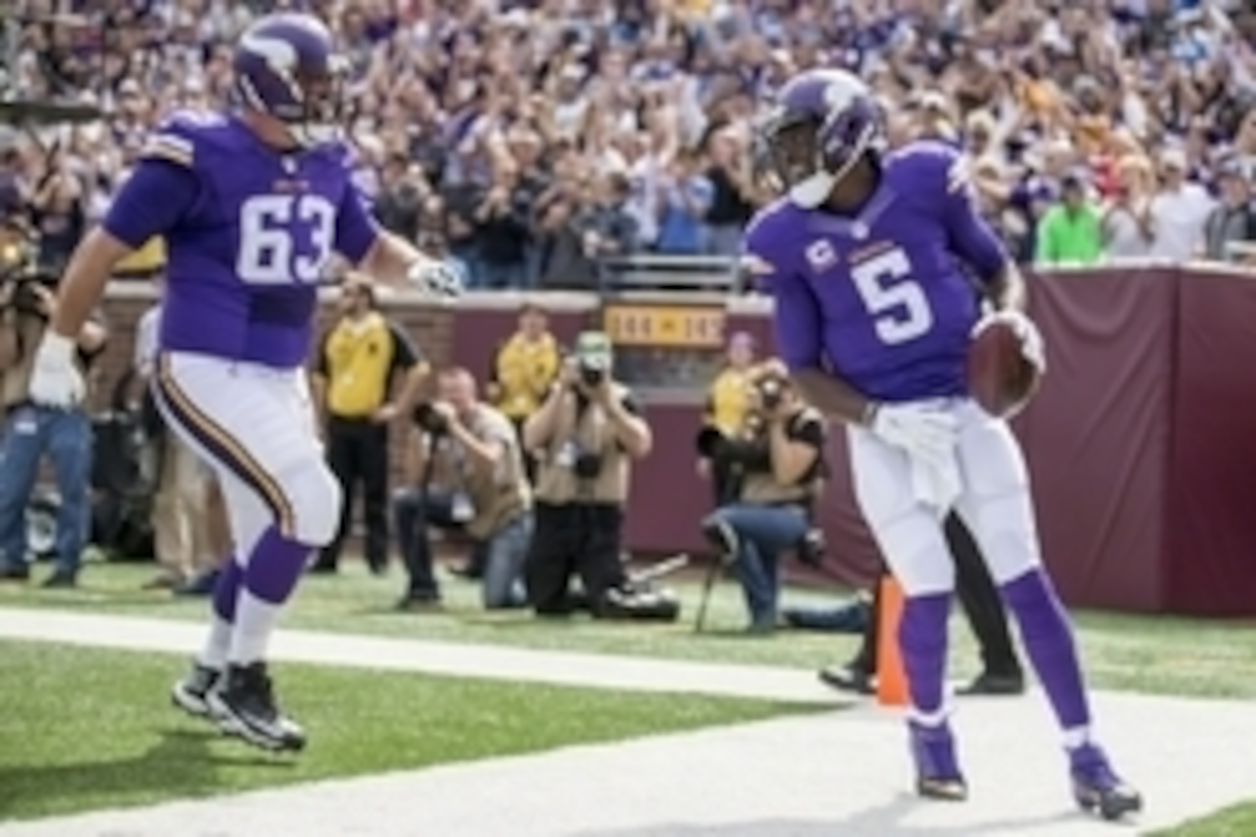 Sep 20, 2015; Minneapolis, MN, USA; Minnesota Vikings quarterback Teddy Bridgewater (5) smiles and celebrates with guard Brandon Fusco (63) after scoring a touchdown in the first half against the Detroit Lions at TCF Bank Stadium. Mandatory Credit: Jesse