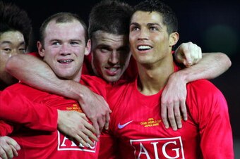 YOKOHAMA, JAPAN - DECEMBER 21:  Wayne Rooney (L) of Manchester United celebrates their first goal with teammates Chrsitiano Ronaldo (R) and Michael Carrick (C) during the FIFA Club World Cup Final match between Manchester United and Liga de Quito at the I