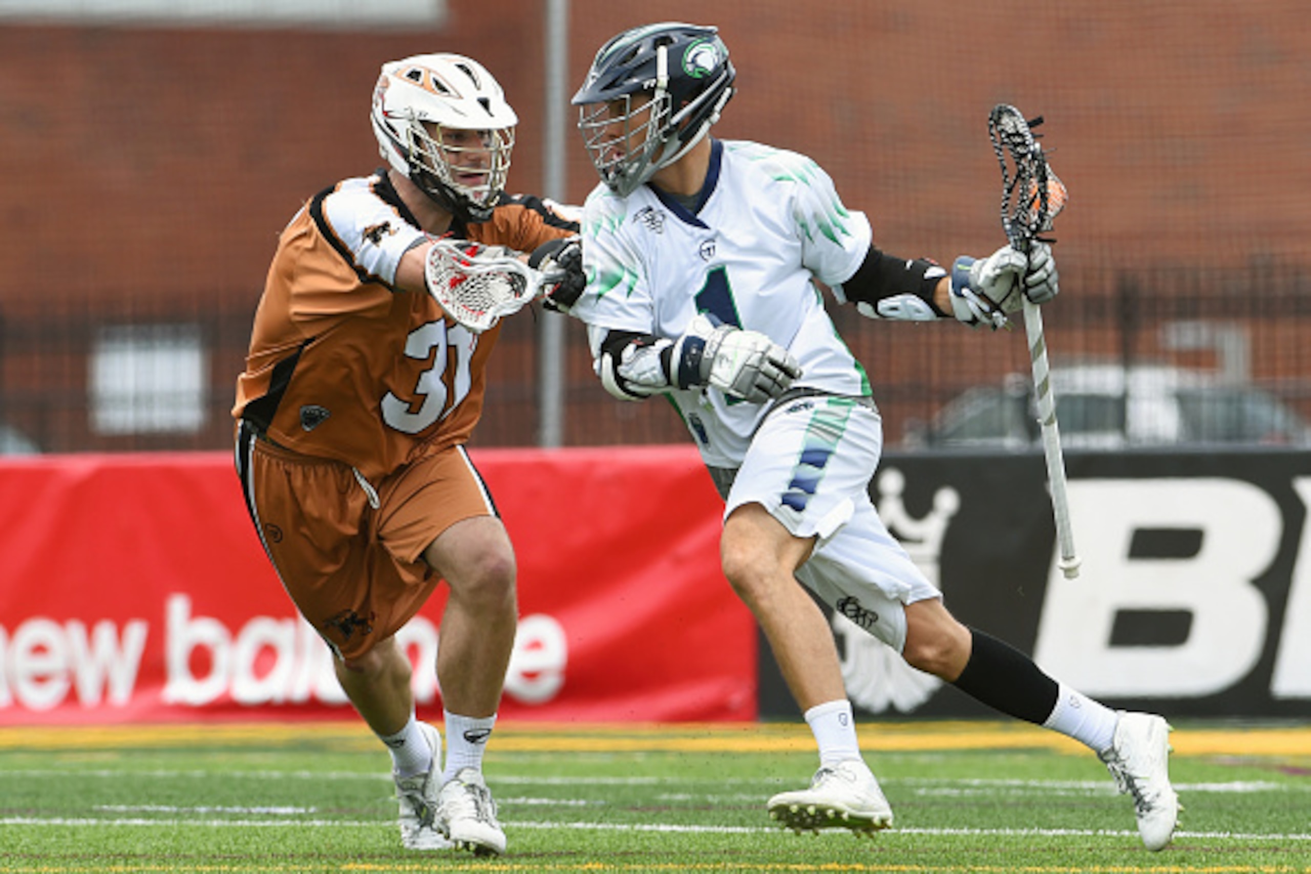 BROCKPORT, NY - JULY 12:  Joe Walters #1 of the Chesapeake Bayhawks dodges to the goal against the defense of John Ranagan #31 of the Rochester Rattlers during the first quarter at Eunice Kennedy Shriver Stadium on July 12, 2015 in Brockport, New York.  T