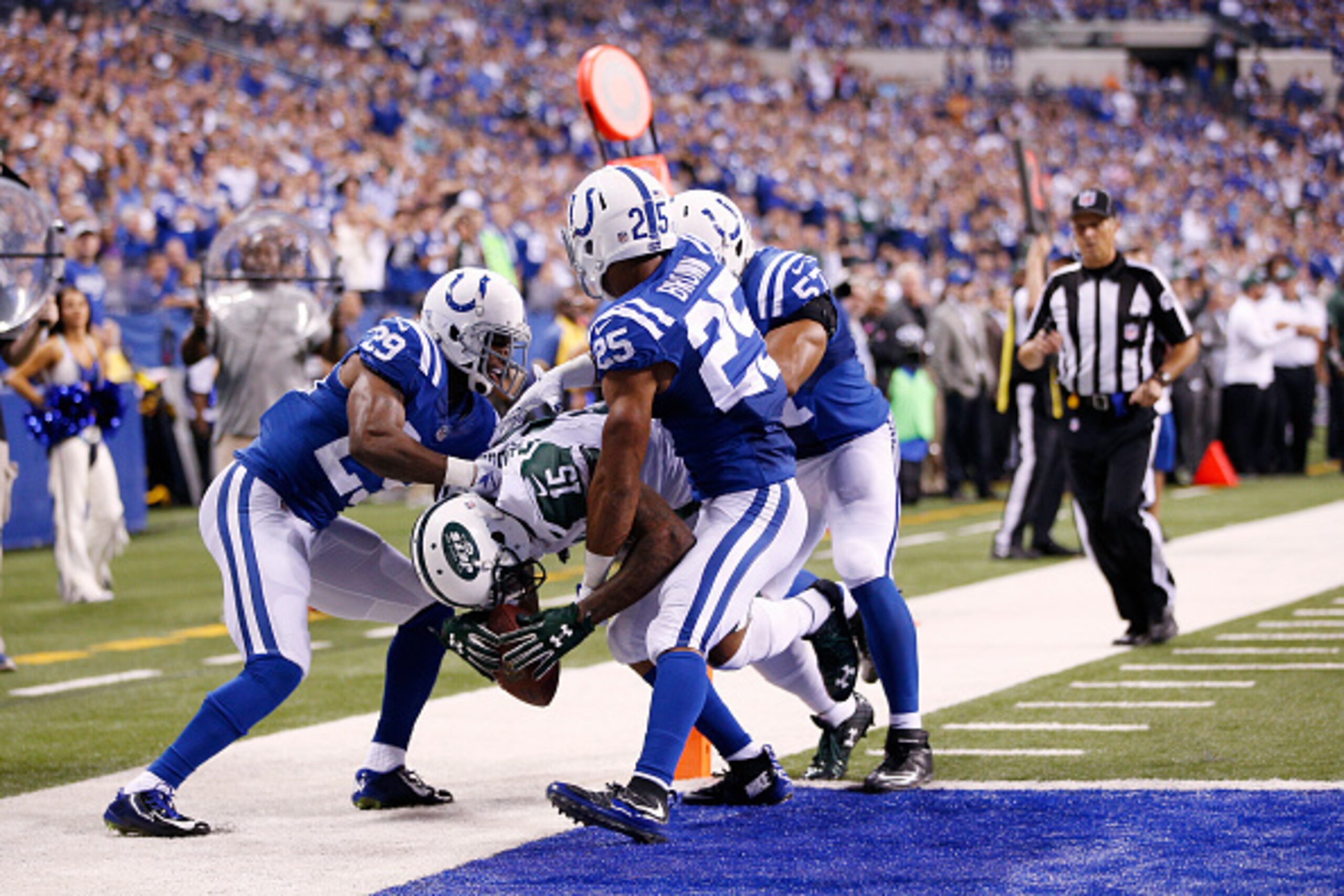 INDIANAPOLIS, IN - SEPTEMBER 21: Brandon Marshall #15 of the New York Jets carries three Indianapolis Colts defenders into the end zone for a 15-yard touchdown in the fourth quarter at Lucas Oil Stadium on September 21, 2015 in Indianapolis, Indiana. (Pho