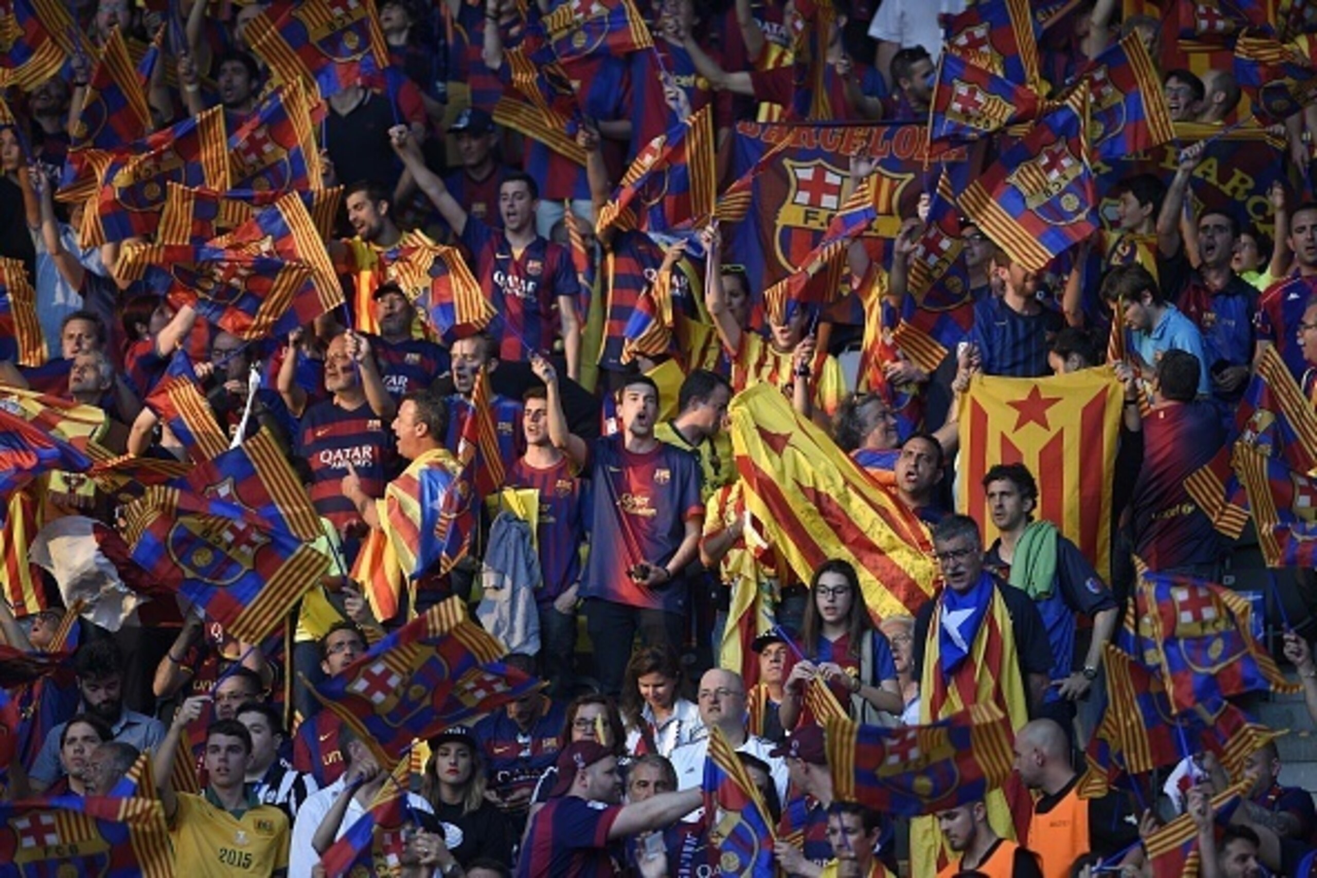 Barcelona's supporters cheer prior to the UEFA Champions League Final football match between Juventus and FC Barcelona at the Olympic Stadium in Berlin on June 6, 2015.     AFP PHOTO / LLUIS GENE        (Photo credit should read LLUIS GENE/AFP/Getty Image