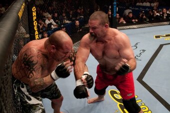 UNCASVILLE, CT - NOVEMBER 22:  (R-L) David 'Tank' Abbott punches Wesley 'Cabbage' Correira during their bout at UFC 45 at the Mohegan Sun Arena on November 22, 2003 in Uncasville, Connecticut.  (Photo by Josh Hedges/Zuffa LLC/Zuffa LLC via Getty Images)
