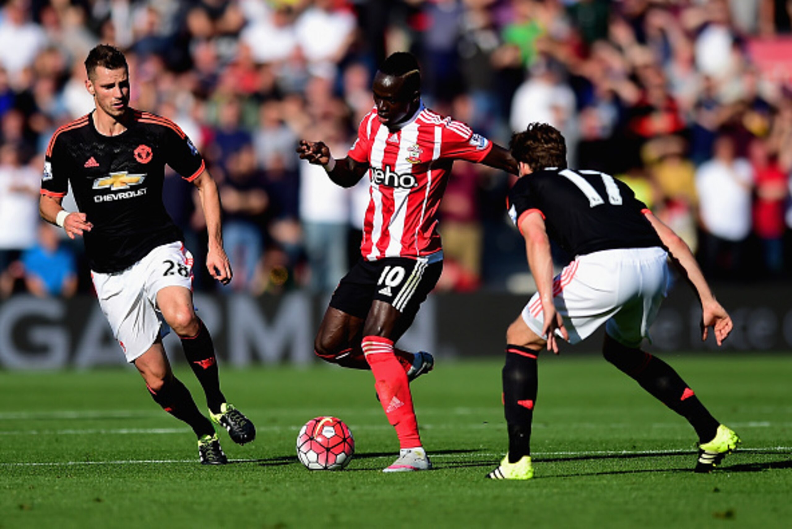SOUTHAMPTON, ENGLAND - SEPTEMBER 20: Sadio Mane of Southampton is closed down by Daley Blind and Morgan Schneiderlin of Manchester United  during the Barclays Premier League match between Southampton and Manchester United at St Mary's Stadium on September