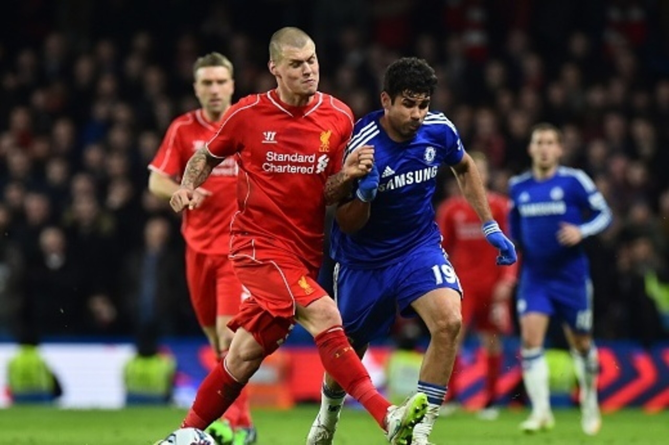 Liverpool's Slovakian defender Martin Skrtel (L) fouls Chelsea's Brazilian-born Spanish striker Diego Costa (R), a challenge for which he was booked, during the English League Cup semi-final second leg football match between Chelsea and Liverpool at Stamf