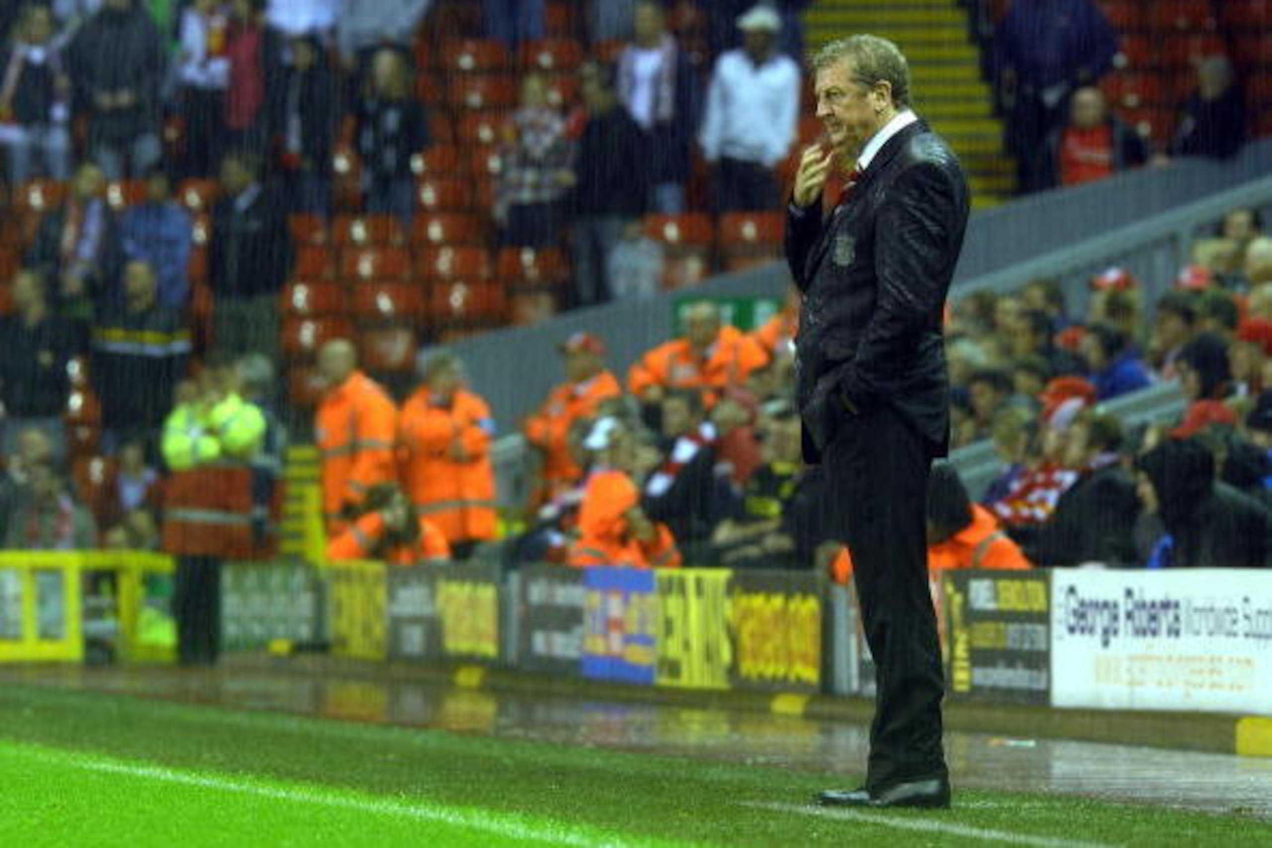 Liverpool Manager Roy Hodgson stands in the rain as Liverpool lose to Northampton in their English Football League football match at Anfield in Liverpool, north-west England, on September 22, 2009. Northampton won after extra time and penalties. AFP PHOTO