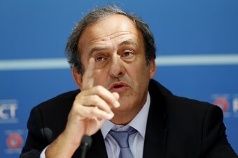 UEFA chief Michel Platini gestures as he speaks during a UEFA press conference after the draw for the UEFA Europa League football group stage 2015/16 on August 28, 2015 in Monaco.  AFP PHOTO / VALERY HACHE        (Photo credit should read VALERY HACHE/AFP