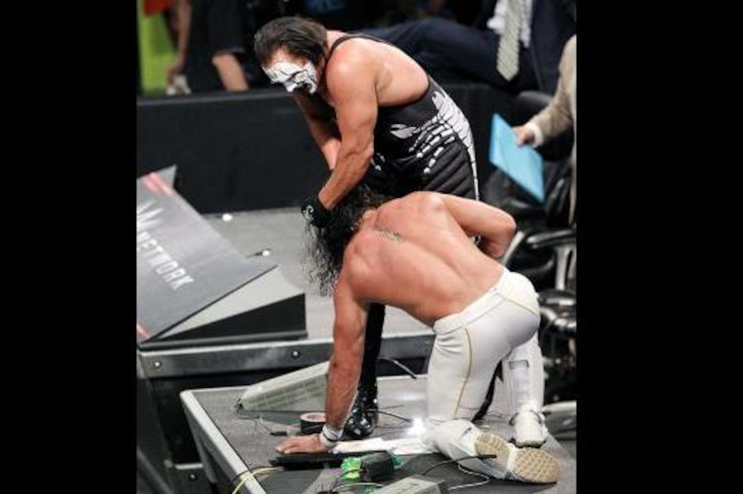 Sting and Seth Rollins battle atop the announce table. Sting and Seth Rollins battle atop the announce table.
