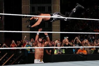 Sting leaps at Seth Rollins.