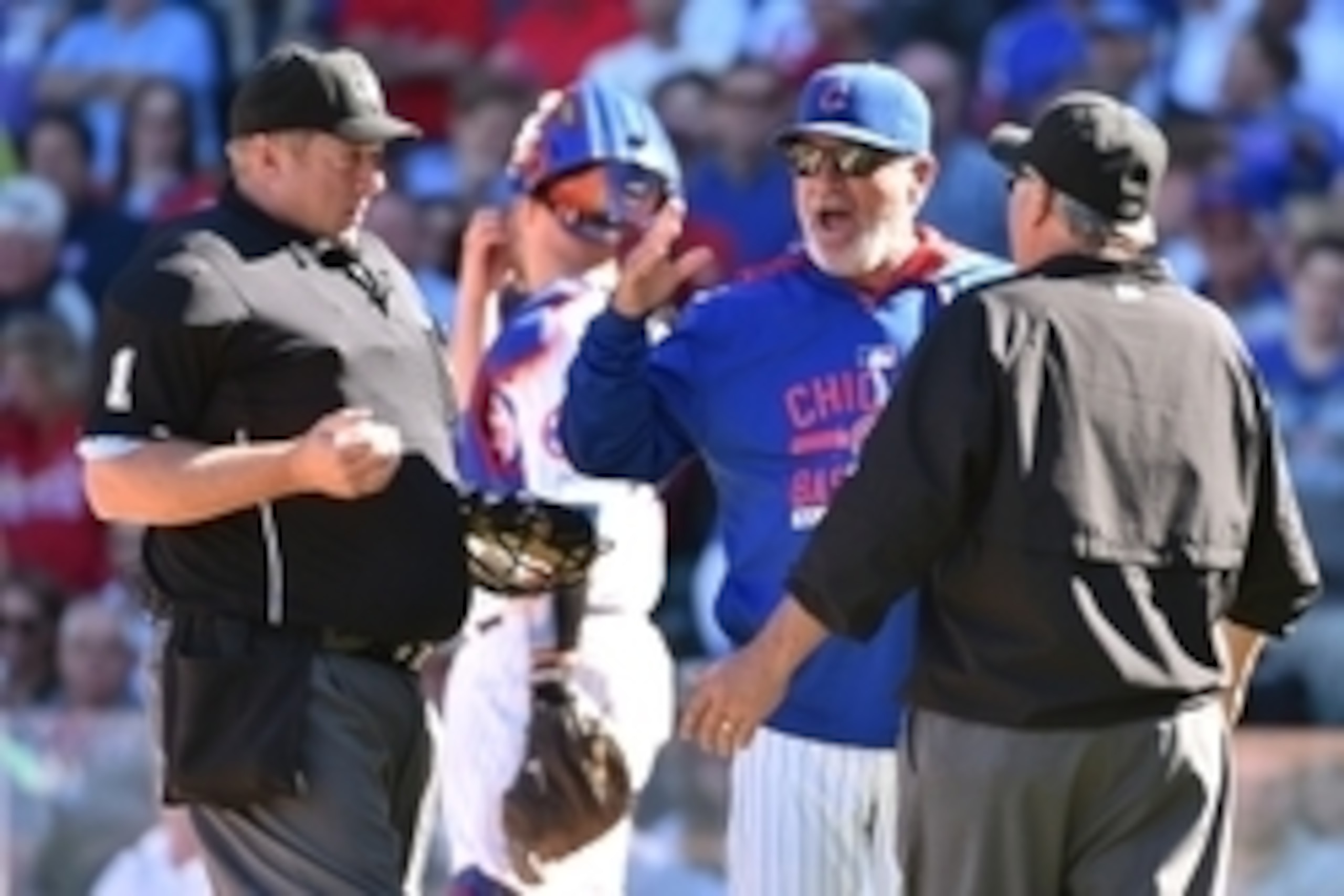 Sep 19, 2015; Chicago, IL, USA; Chicago Cubs manager Joe Maddon (70) argues with umpire Bruce Dreckman (1) and umpire Tom Hallion (20) at Wrigley Field. Mandatory Credit: Jasen Vinlove-USA TODAY Sports