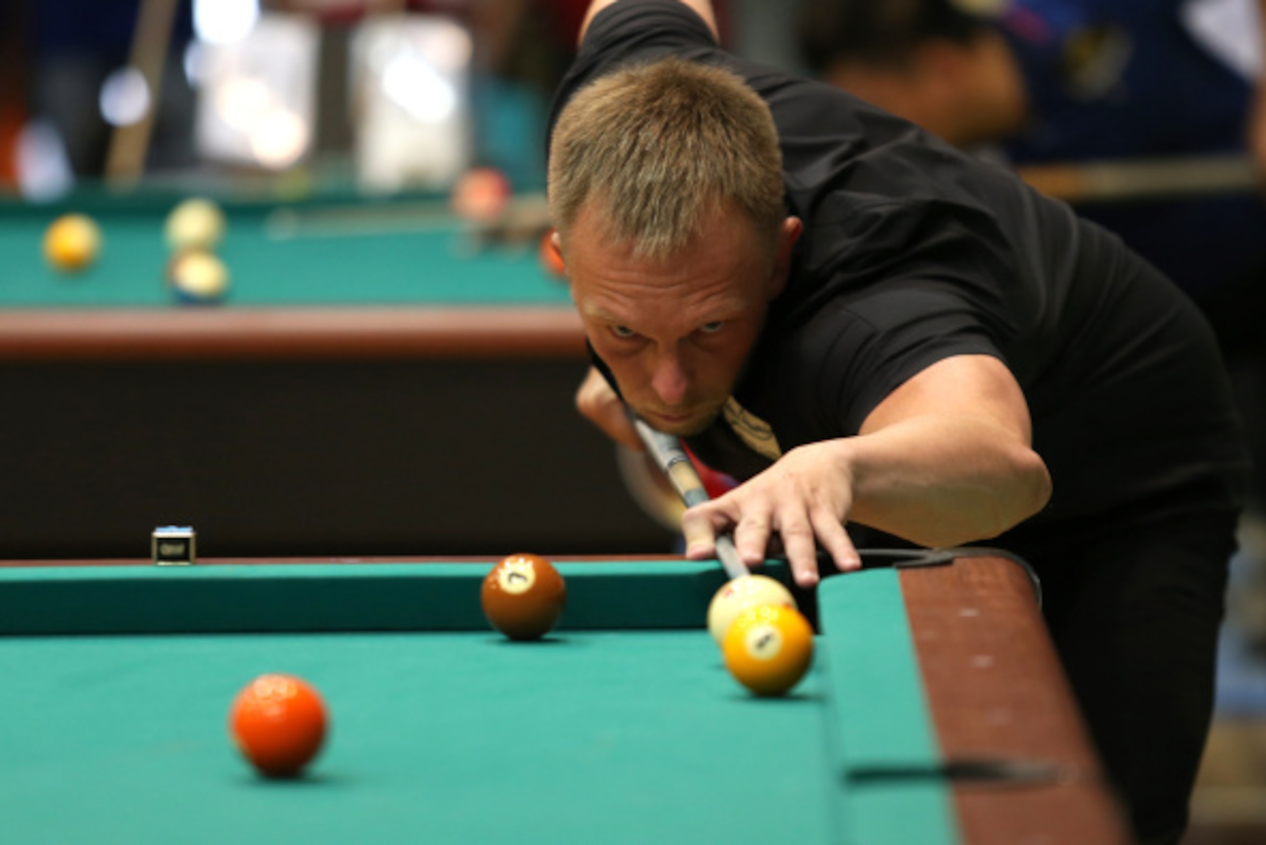 GENERAL SANTOS, PHILIPPINES - SEPTEMBER 03: Thorsten Hohmann of Germany plays a shot against Lauro Bongay of the Philippines during the day two in the winners bracket category of the International Open Single 10-Ball Billiards Tournament on September 3, 2