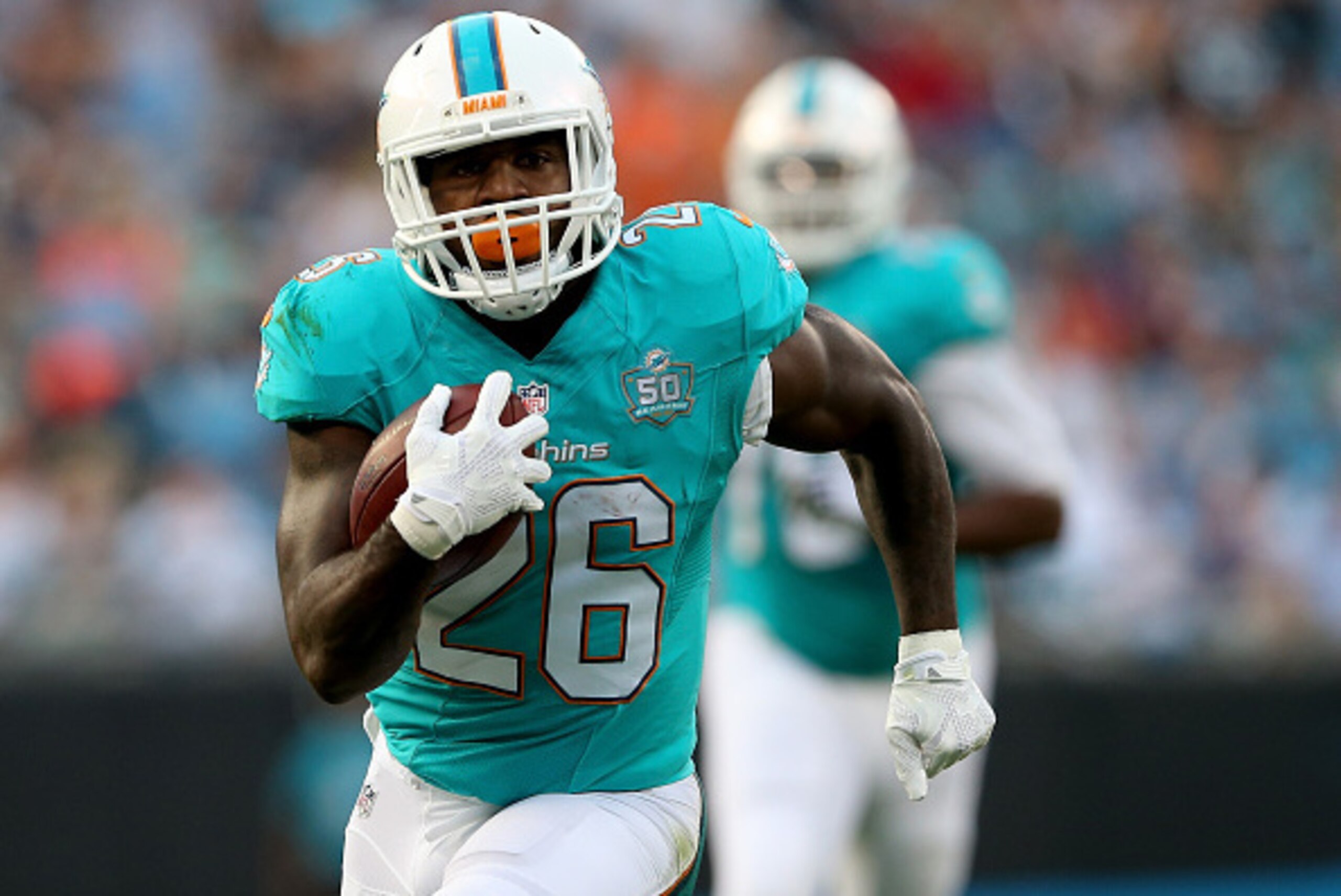 CHARLOTTE, NC - AUGUST 22:  Lamar Miller #26 of the Miami Dolphins during their game at Bank of America Stadium on August 22, 2015 in Charlotte, North Carolina.  (Photo by Streeter Lecka/Getty Images)