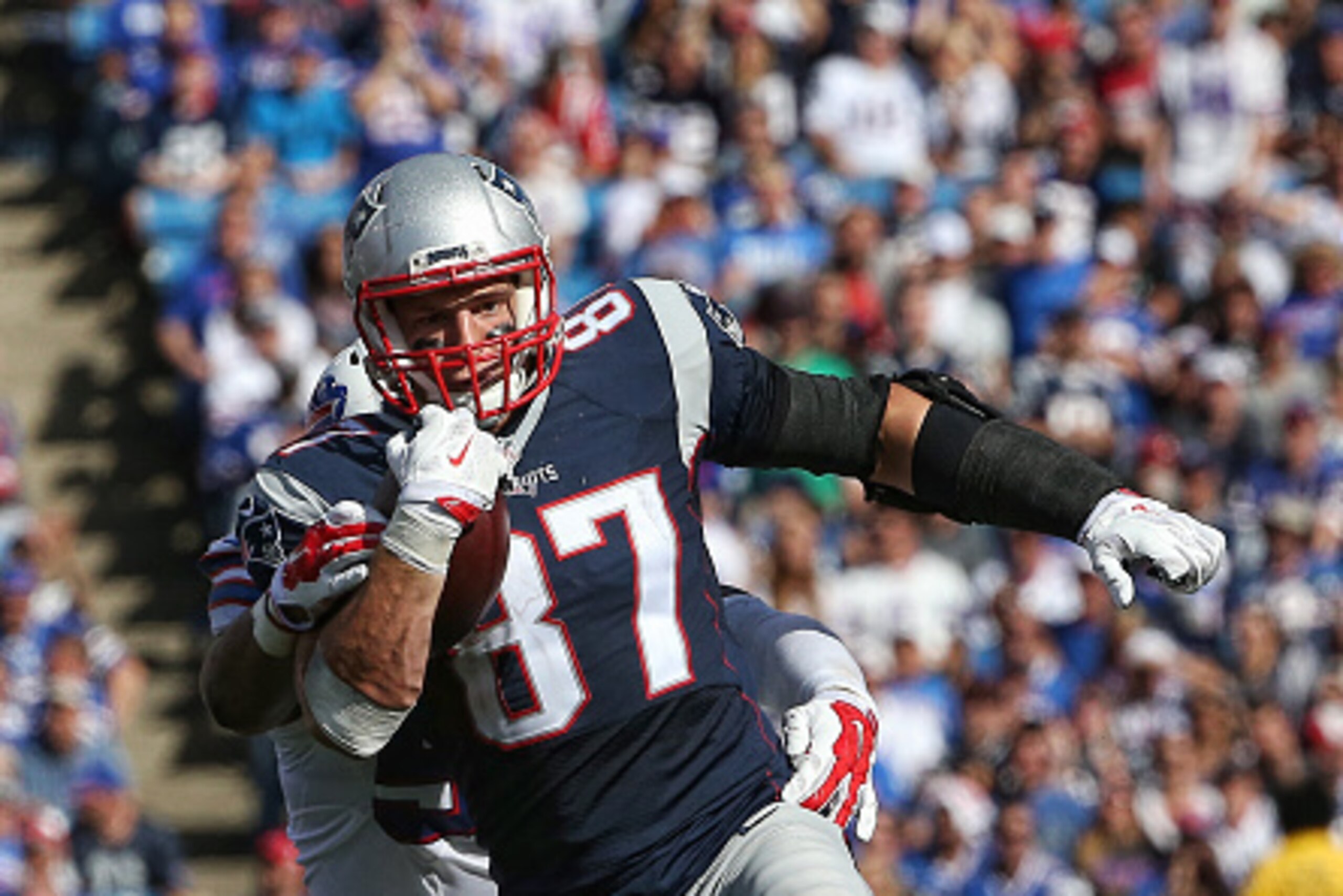 ORCHARD PARK, NY - SEPTEMBER 20: Rob Gronkowski #87 of the New England Patriots runs after the catch during NFL game action as he is chased by Preston Brown #52 of the Buffalo Bills at Ralph Wilson Stadium on September 20, 2015 in Orchard Park, New York. 