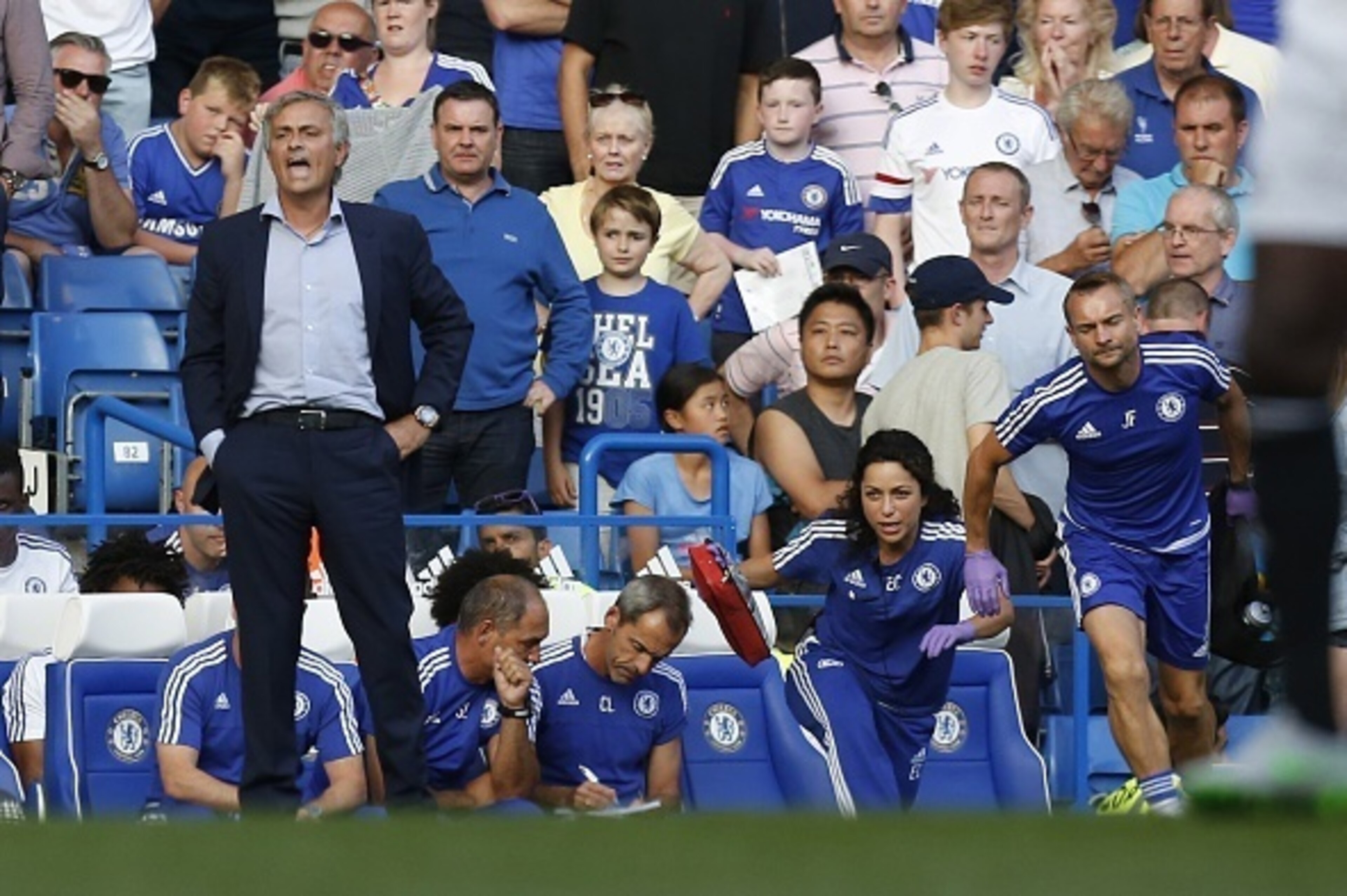 Chelsea doctor (2R) Eva Carneiro and head physio Jon Fearn (R) leave the bench to treat Chelsea's Belgian midfielder Eden Hazard late in the game as Chelsea's Portuguese manager Jose Mourinho (L) gestures during the English Premier League football match b