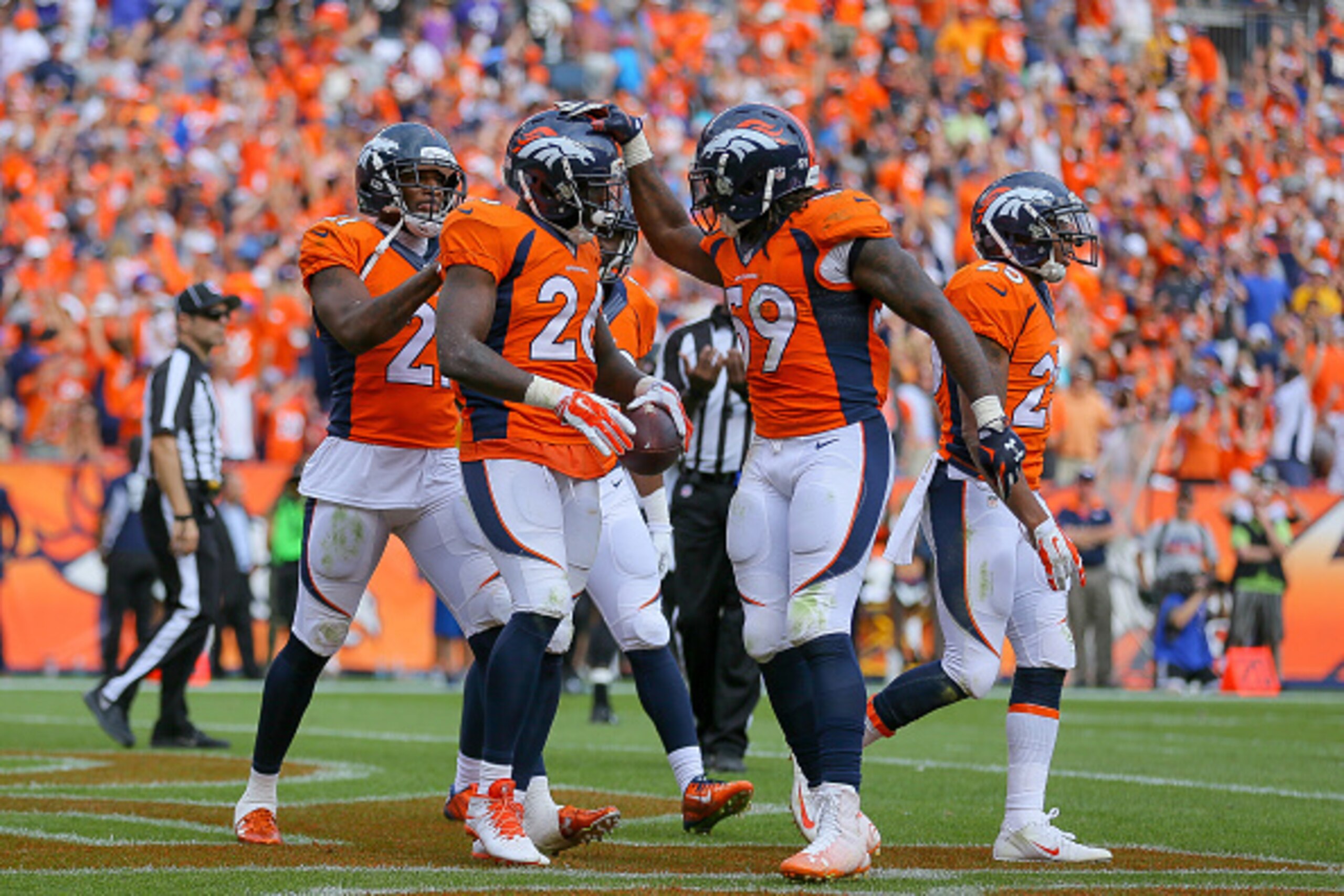 DENVER, CO - SEPTEMBER 13: Defensive back Darian Stewart #26 of the Denver Broncos celebrates with Danny Trevathan #59 and Aqib Talib #21 after making a game-ending interception in the fourth quarter of a game at Sports Authority Field at Mile High on Sep