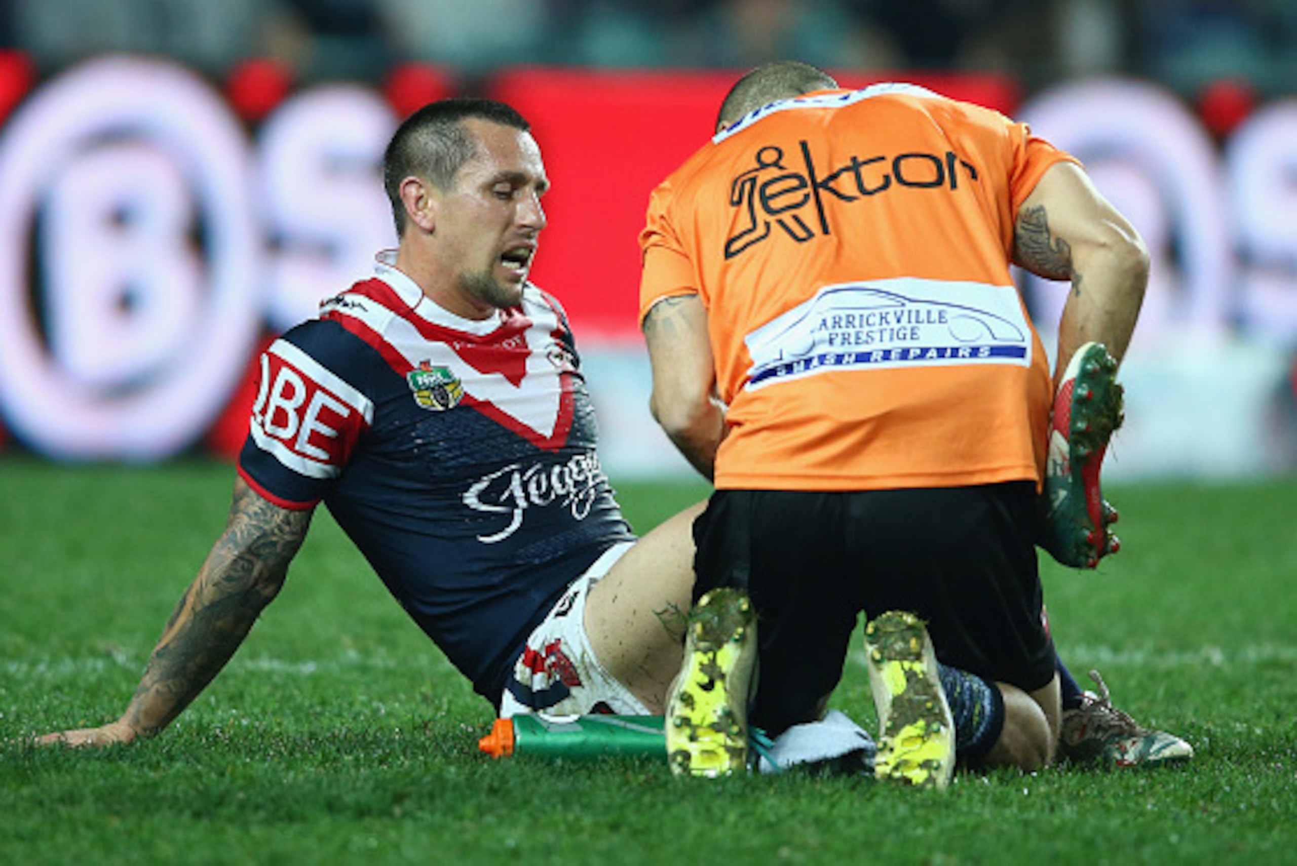 SYDNEY, AUSTRALIA - AUGUST 22:  Mitchell Pearce of the Roosters receives attention from the trainer during the round 24 NRL match between the Sydney Roosters and the Brisbane Broncos at Allianz Stadium on August 22, 2015 in Sydney, Australia.  (Photo by M