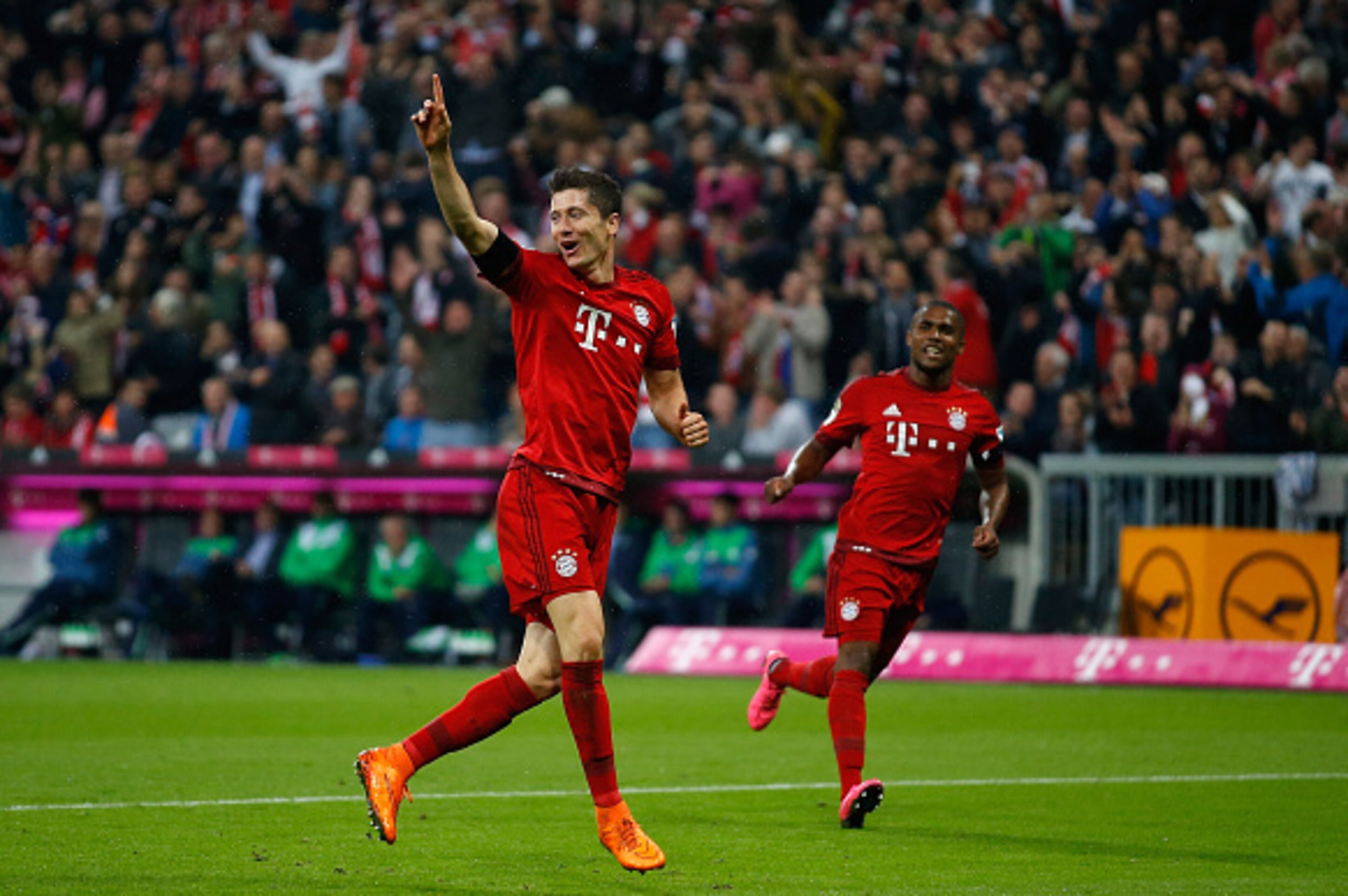 MUNICH, GERMANY - SEPTEMBER 22:  Robert Lewandowski (L) of Bayern Munich celebrates after scoring his 5th goal during the Bundesliga match between FC Bayern Muenchen and VfL Wolfsburg at Allianz Arena on September 22, 2015 in Munich, Germany.  (Photo by B