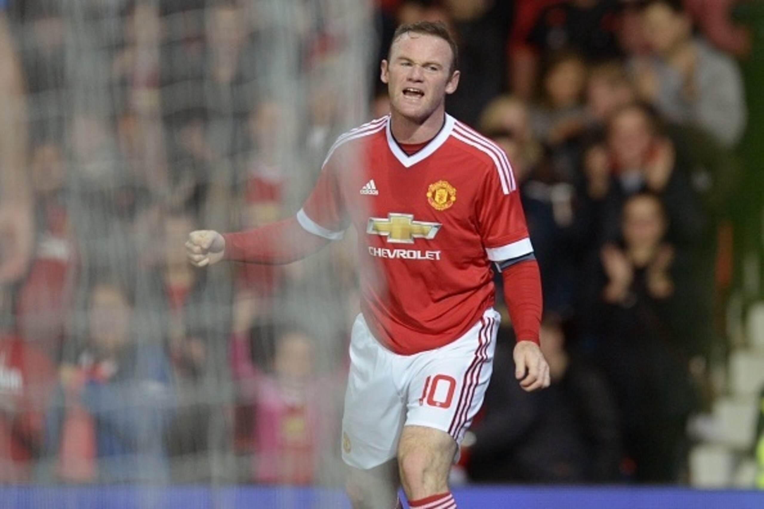 Manchester United's English striker Wayne Rooney celebrates after scoring the opening goal of the English League Cup third round football match between Manchester United and Ipswich Town at Old Trafford in Manchester, north west England on September 23, 2