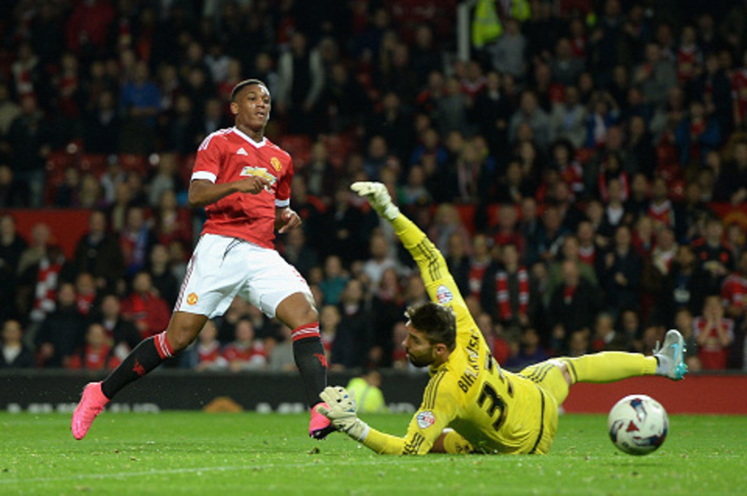 MANCHESTER, ENGLAND - SEPTEMBER 23:  Anthony Martial of Manchester United scores his team's third goal past Bartosz Bialkowski of Ipswich Town during the Capital One Cup Third Round match between Manchester United and Ipswich Town at Old Trafford on Septe