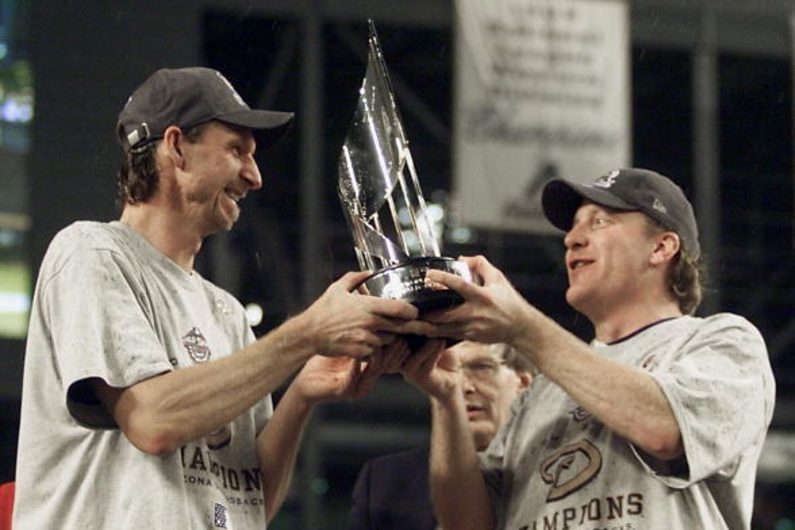 PHOENIX, UNITED STATES:  World Series co-MVPs Arizona Diamondbacks pitchers Randy Johnson (L) and Curt Schilling hold their MVP trophy during post-game ceremonies after the Diamondbacks' win of Game 7 of the World Series in Phoenix 04 November 2001. The D