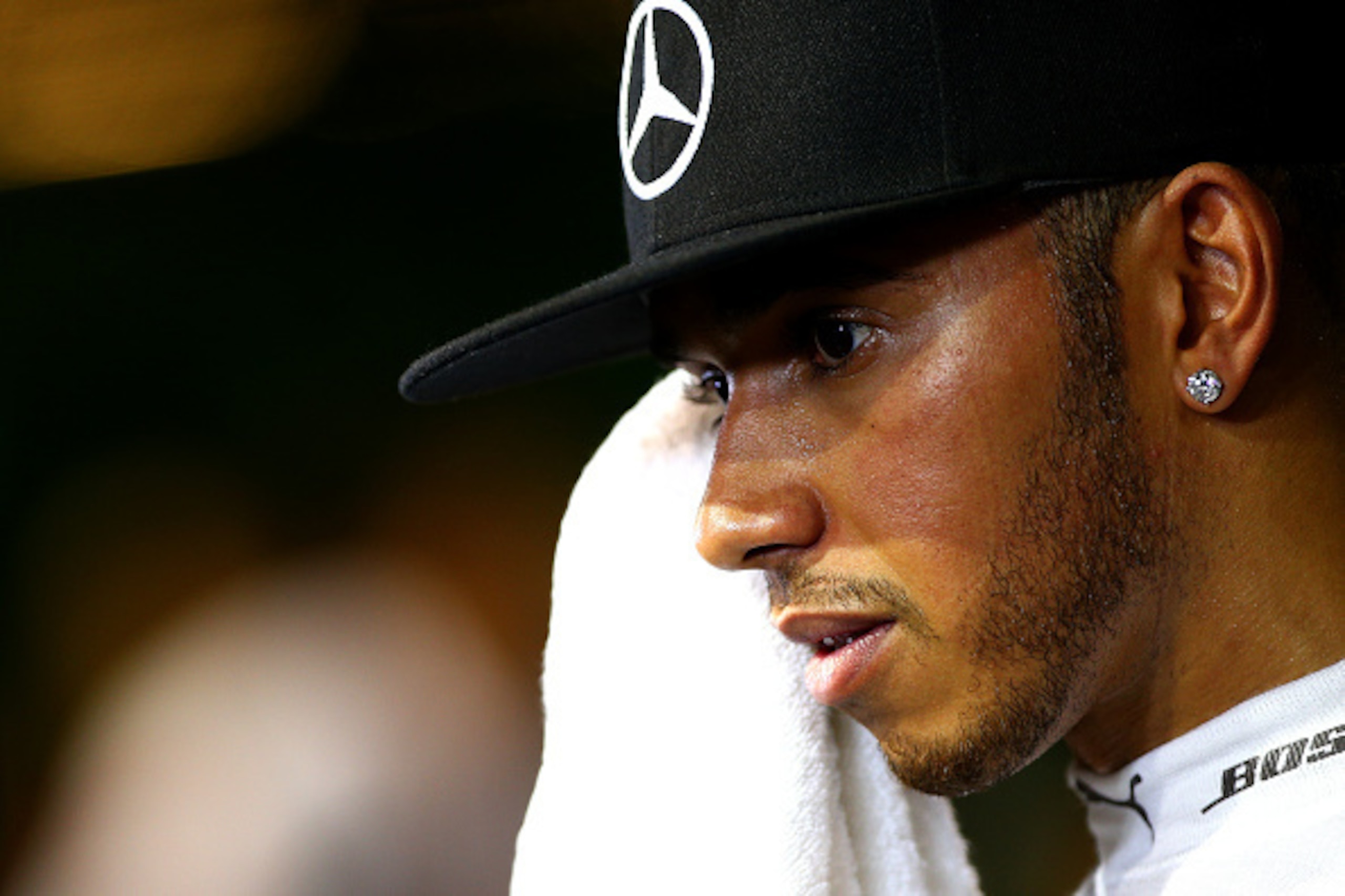SINGAPORE - SEPTEMBER 20:  Lewis Hamilton of Great Britain and Mercedes GP speaks with members of the media in the paddock after retiring from the Formula One Grand Prix of Singapore at Marina Bay Street Circuit on September 20, 2015 in Singapore.  (Photo