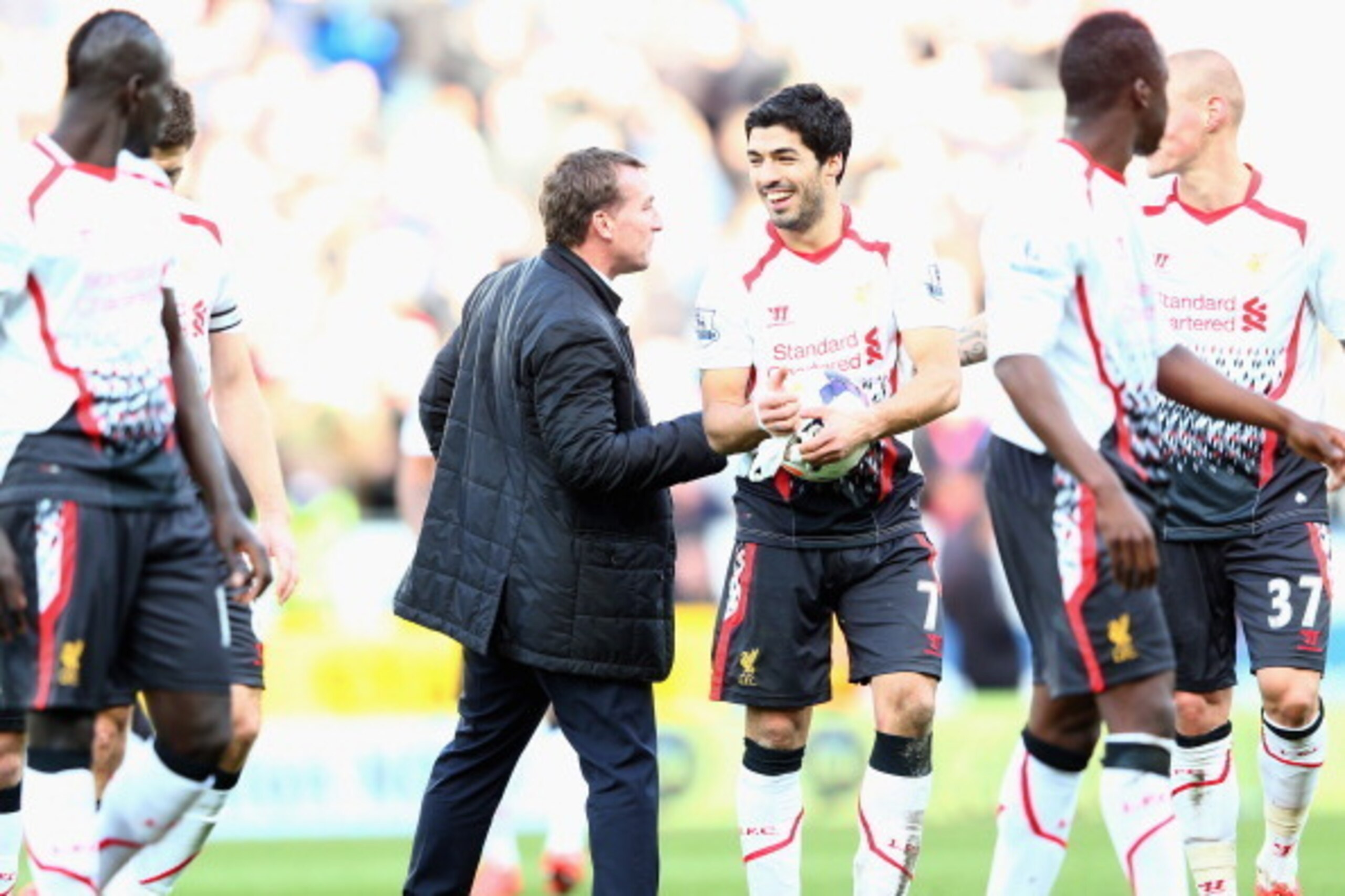 CARDIFF, WALES - MARCH 22:  Luis Suarez (3R) of Liverpool is congratulated by his manager Brendan Rodgers (L) at the final whistle after scoring a hat trick during his teams 6-3 victory during the Barclays Premier League match between Cardiff City and Liv