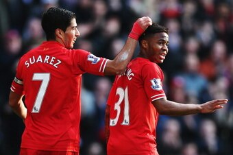 LIVERPOOL, ENGLAND - DECEMBER 21:  (L-R) Luis Suarez and Raheem Sterling of Liverpool react during the Barclays Premier League match between Liverpool and Cardiff City at Anfield on December 21, 2013 in Liverpool, England.  (Photo by Clive Brunskill/Getty